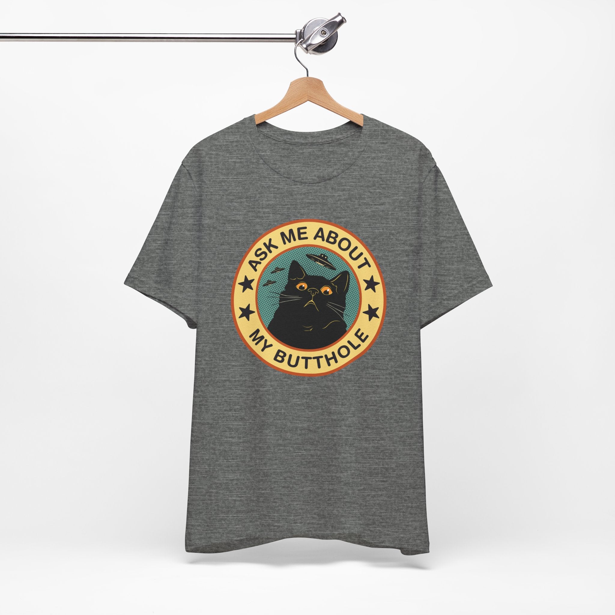 Gray t-shirt with a graphic design featuring a cat and text on a hanger against a white background