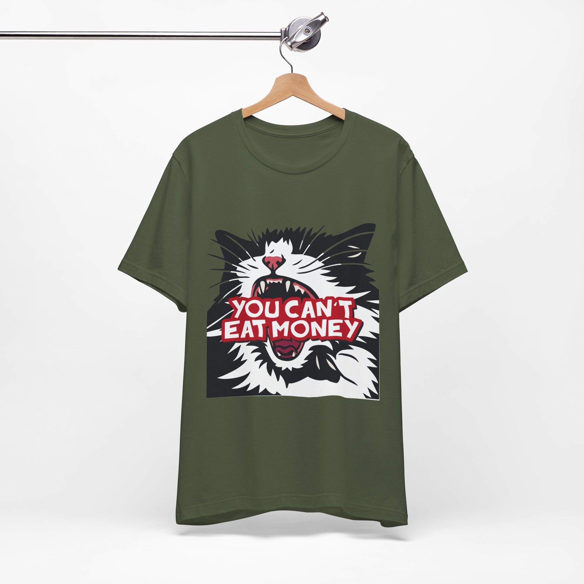 green t-shirt featuring a bold black, white, and red angry cat graphic with the phrase “You Can’t Eat Money.”
