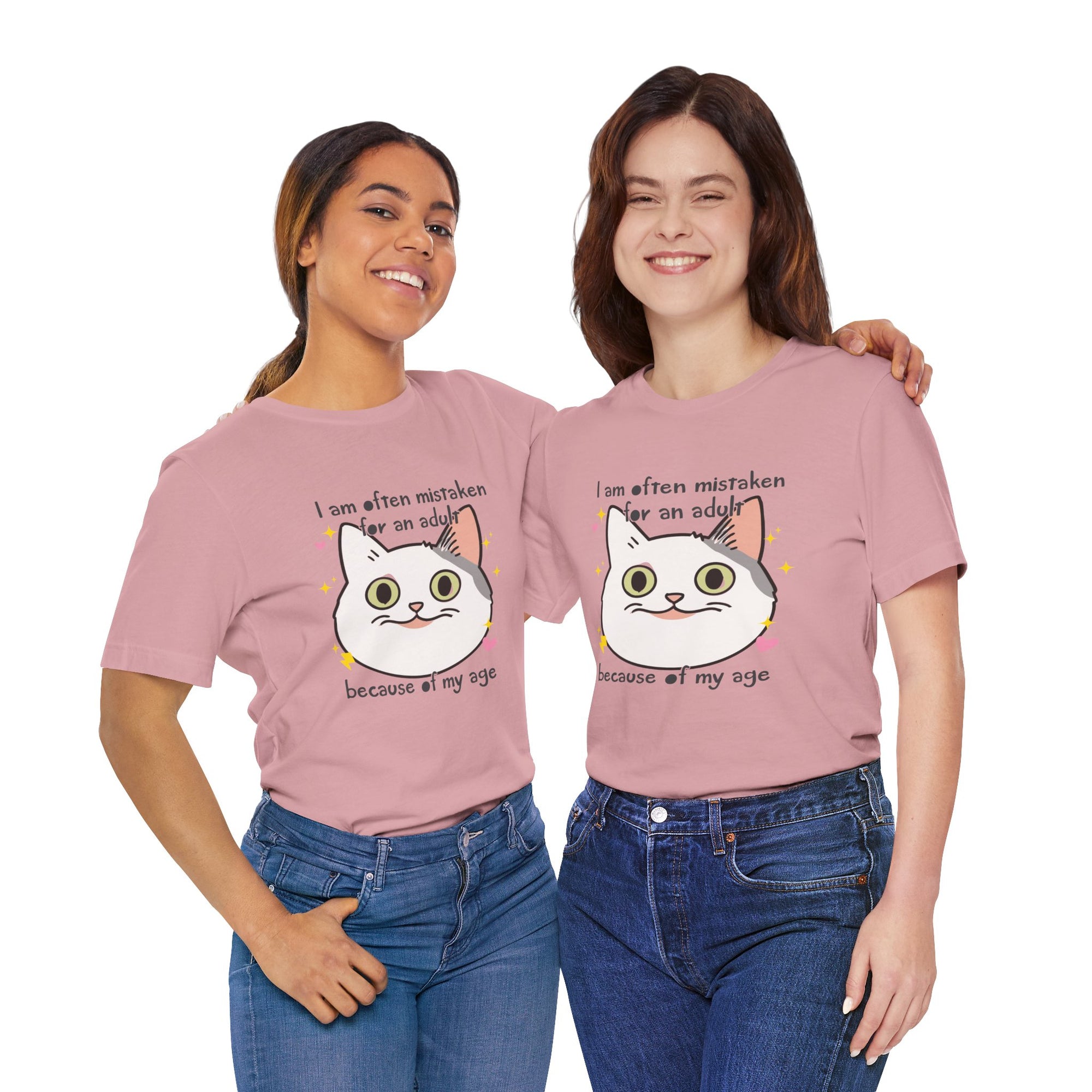 Two women wearing pink t-shirts with a cat graphic and text.
