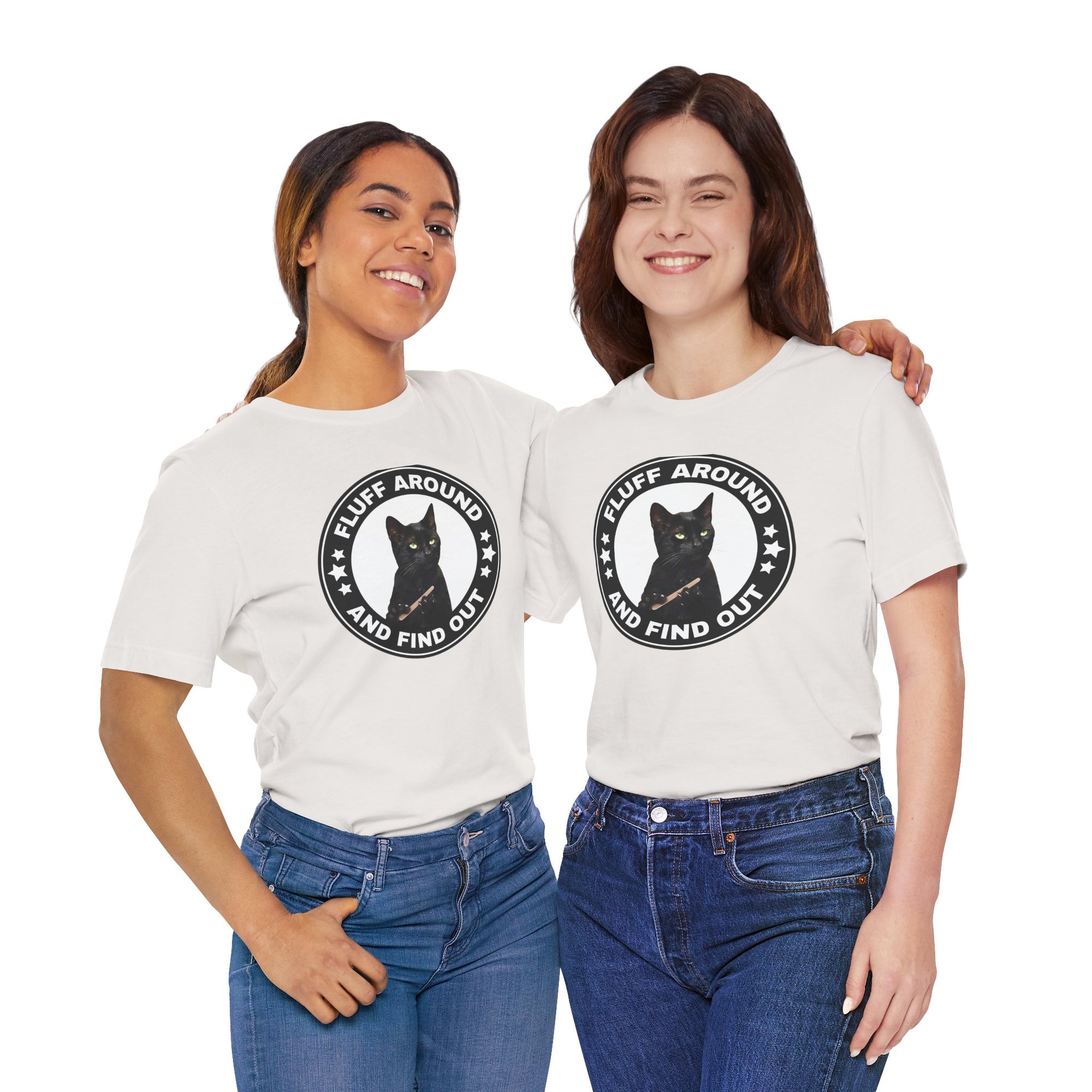 Two people wearing white t-shirt featuring a circular badge design with a black cat and the phrase “Fluff Around and Find Out.”