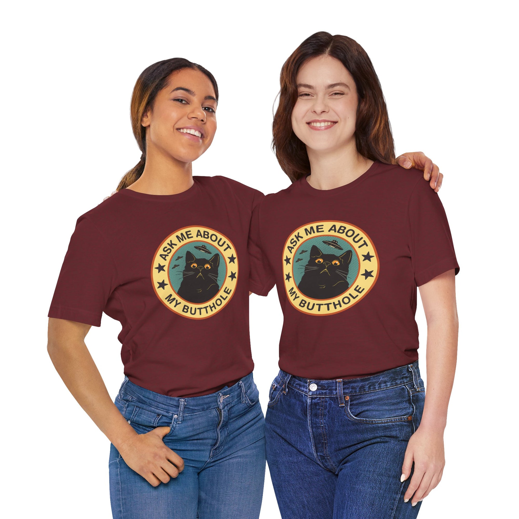 t-shirt featuring a retro-style circular black cat badge with stars, bats, and the phrase “Ask Me About My Butthole.”
