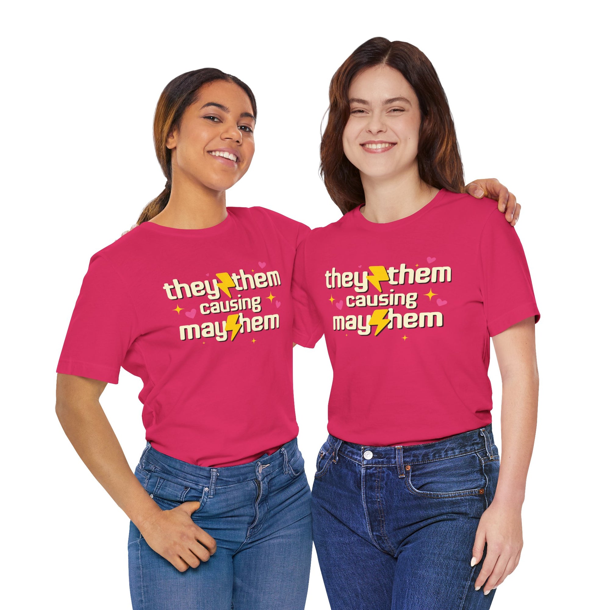 Two people wearing pink t-shirts with 'they them causing mayhem' text.