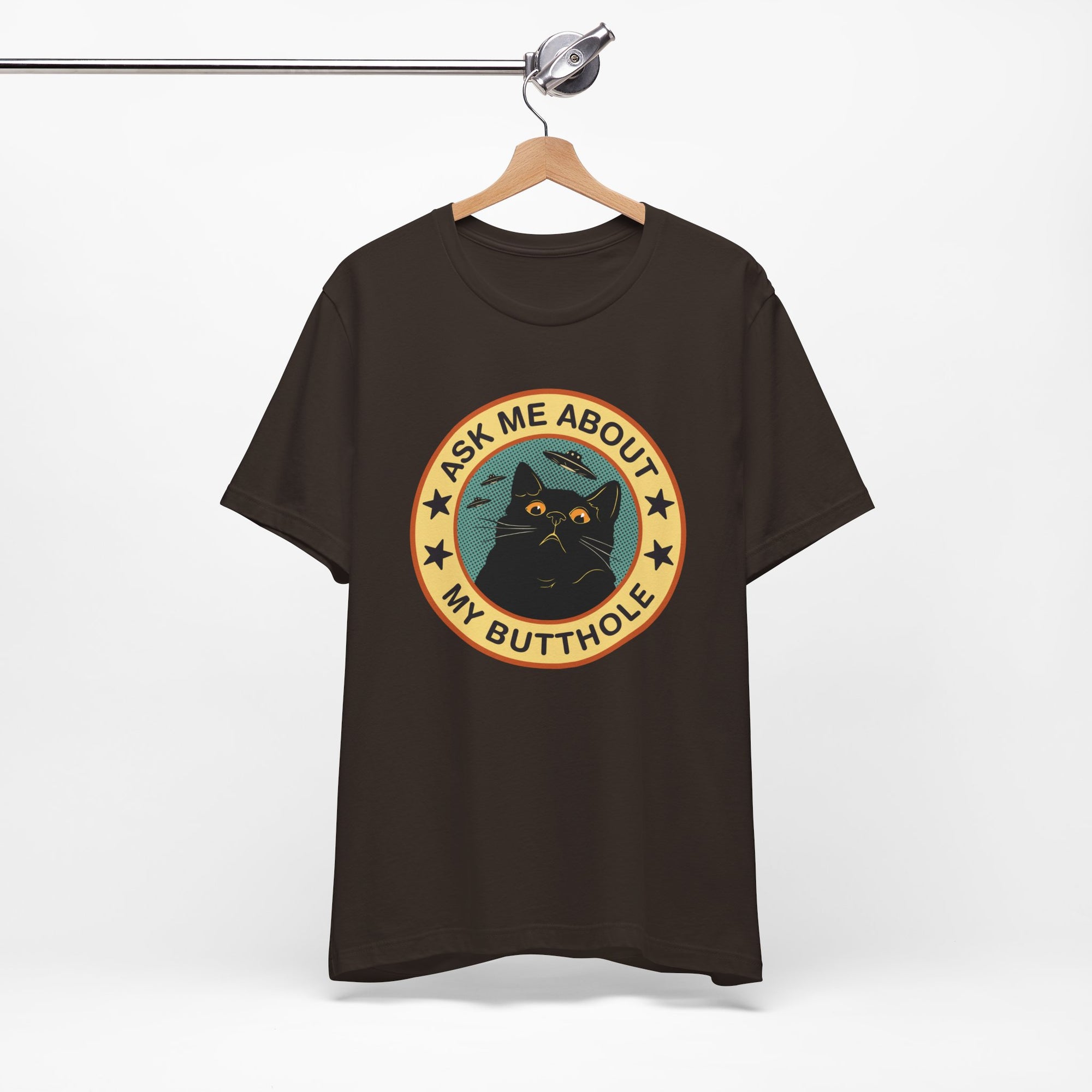 Black t-shirt with a graphic design featuring a cat and text on a hanger against a white background