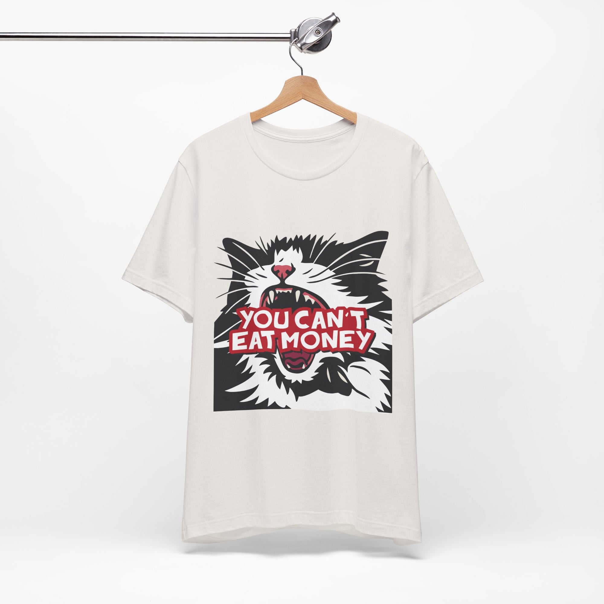 Off white t-shirt featuring a bold black, white, and red angry cat graphic with the phrase “You Can’t Eat Money.”
