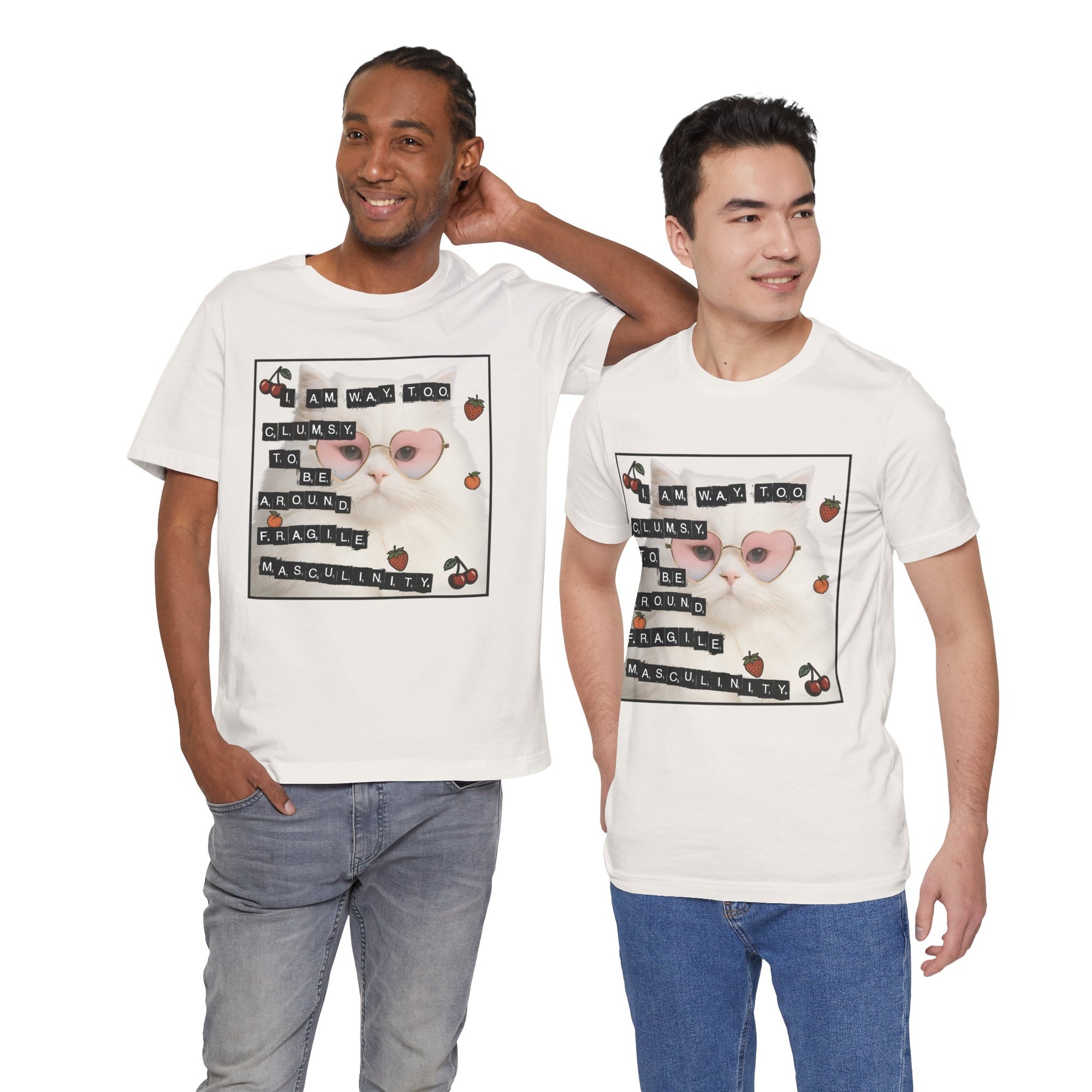 Two men wearing white t-shirt featuring a fluffy white cat in pink heart-shaped sunglasses with ransom-note style text that says “I am way too clumsy to be around fragile masculinity.”