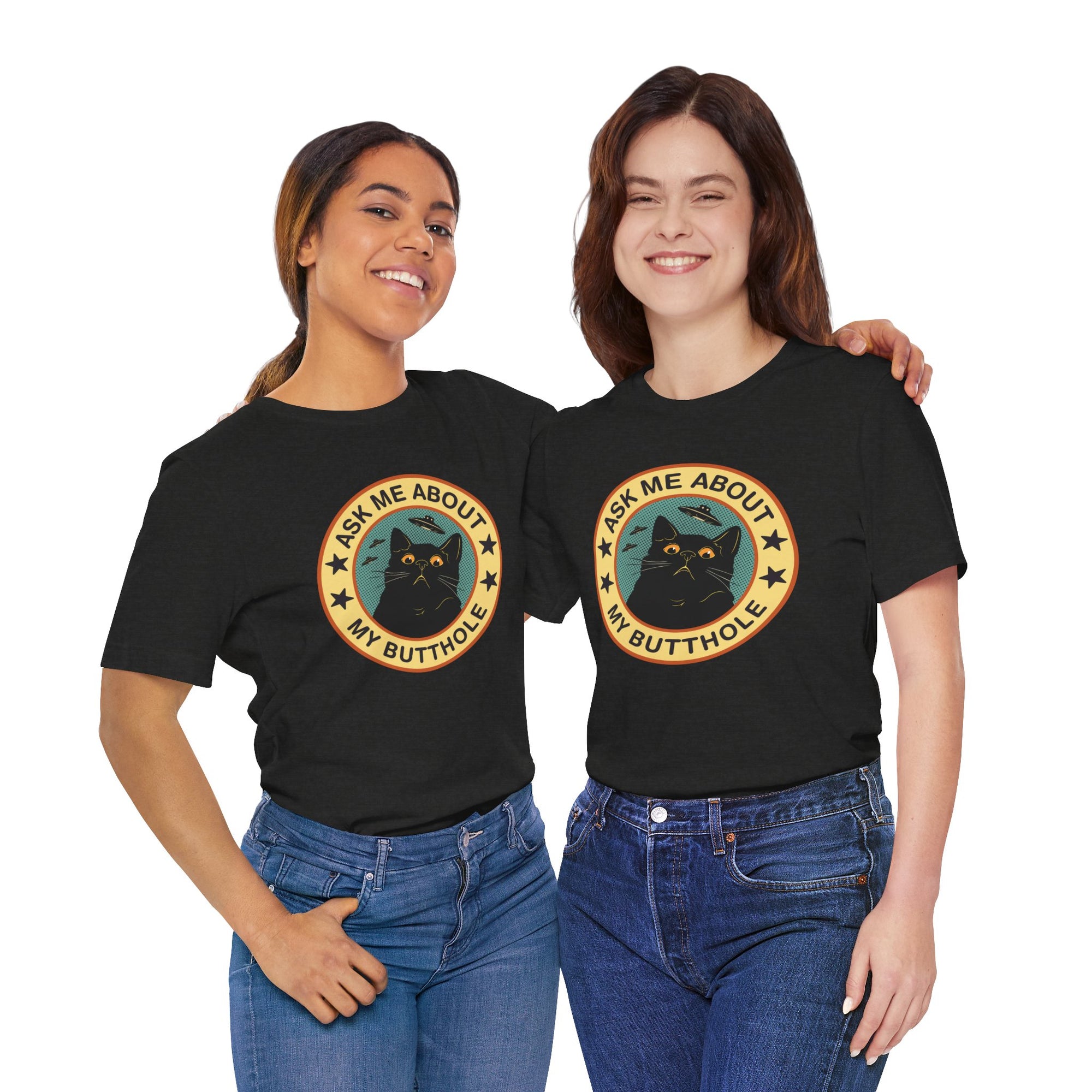Black t-shirt featuring a retro-style circular black cat badge with stars, bats, and the phrase “Ask Me About My Butthole.”
