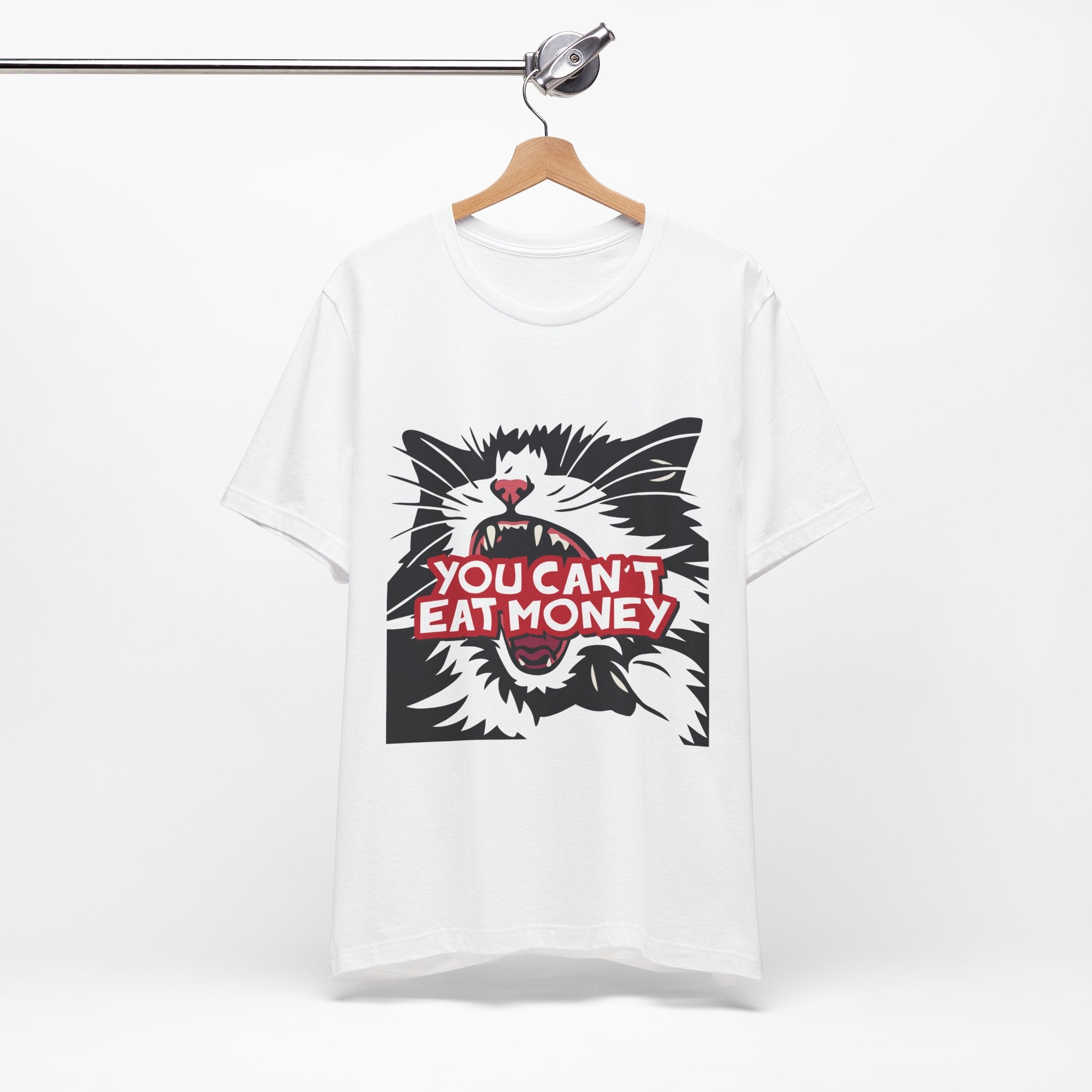 White t-shirt featuring a bold black, white, and red angry cat graphic with the phrase “You Can’t Eat Money.”