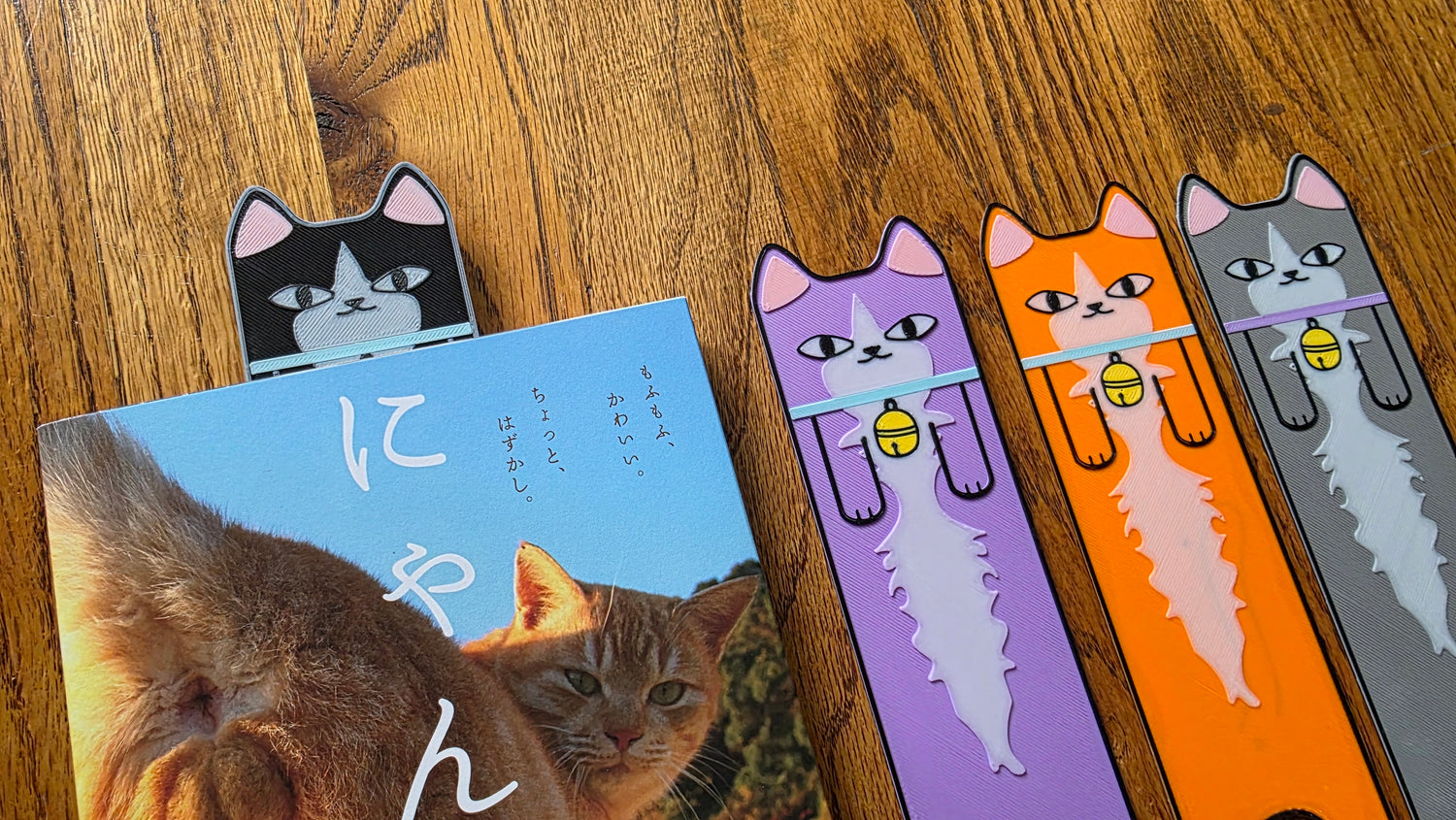 Set of cat-themed bookmarks on a wooden surface