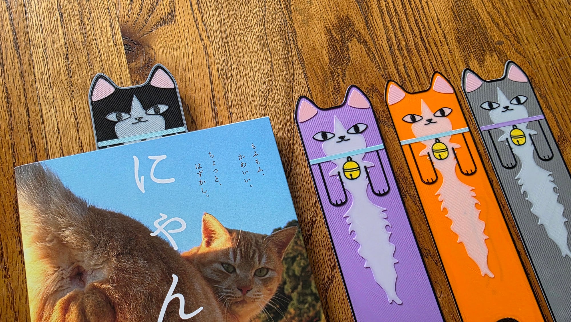 Set of cat-themed bookmarks on a wooden surface
