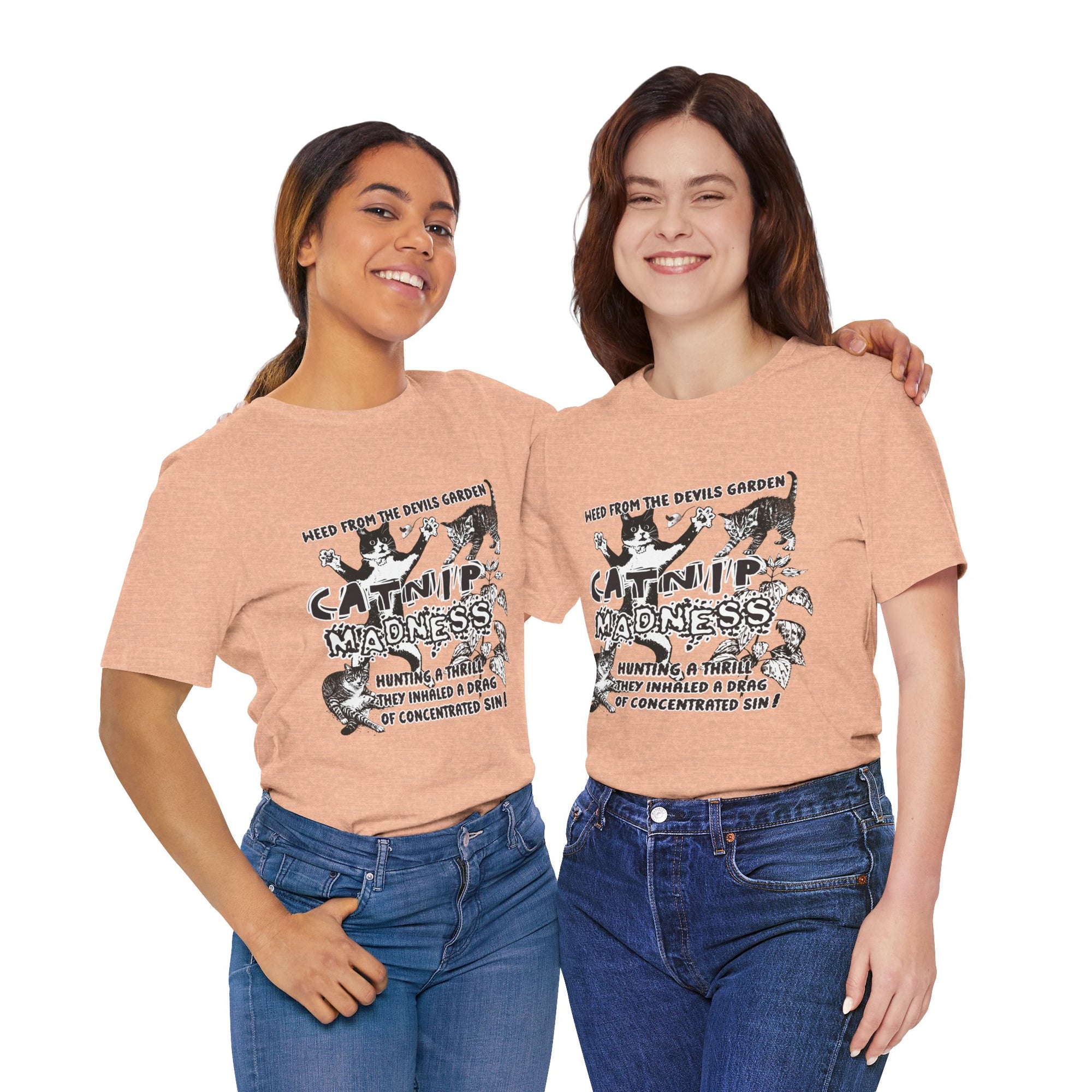 Two women wearing peach t-shirts with a graphic design and text.