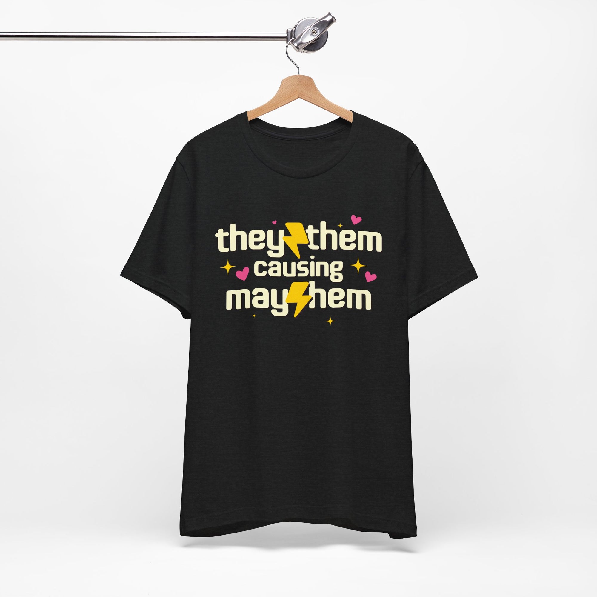 Black t-shirt with 'they them causing mayhem' text on a hanger against a white background