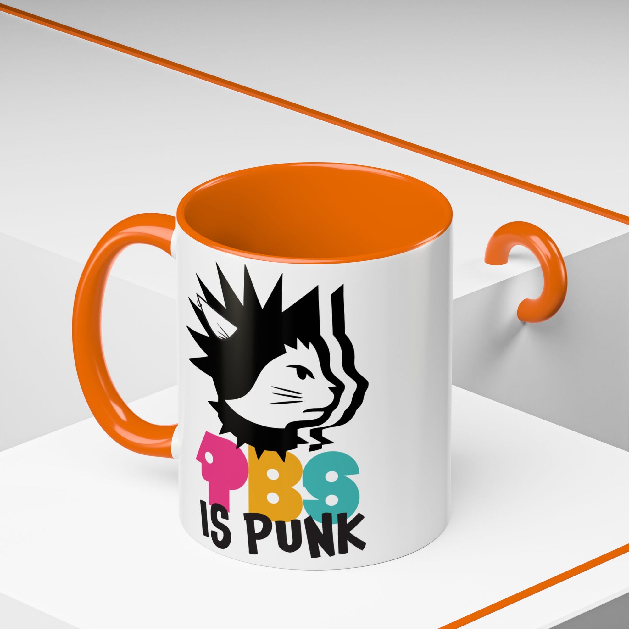 Mug with orange interior and handle, featuring a graphic of a cat and text 'PBS IS PUNK' on a white background.