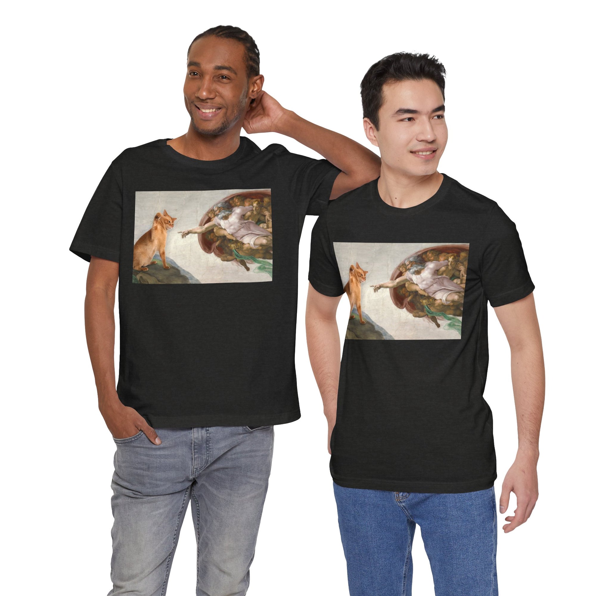 Two men wearing black t-shirts with a graphic design of a cat and god on a white background.