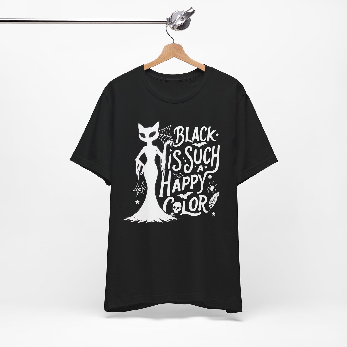 Black t-shirt featuring a white spooky cat graphic with the phrase “Black Is Such a Happy Color,” plus bats, spiderwebs, stars, and Halloween details.
