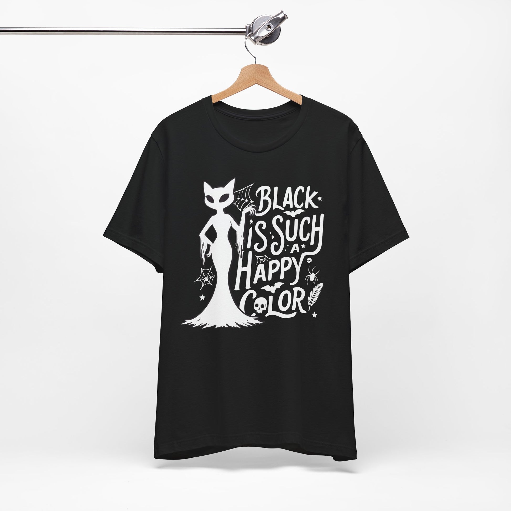 Black t-shirt featuring a white spooky cat graphic with the phrase “Black Is Such a Happy Color,” plus bats, spiderwebs, stars, and Halloween details.
