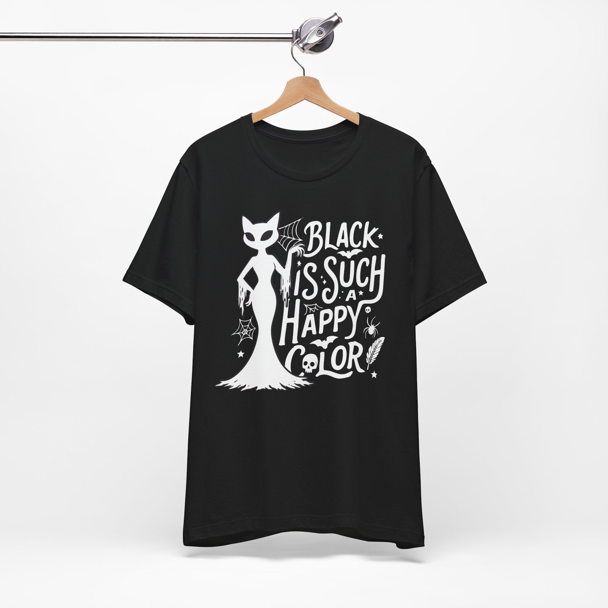 Black t-shirt featuring a white spooky cat graphic with the phrase “Black Is Such a Happy Color,” plus bats, spiderwebs, stars, and Halloween details.
