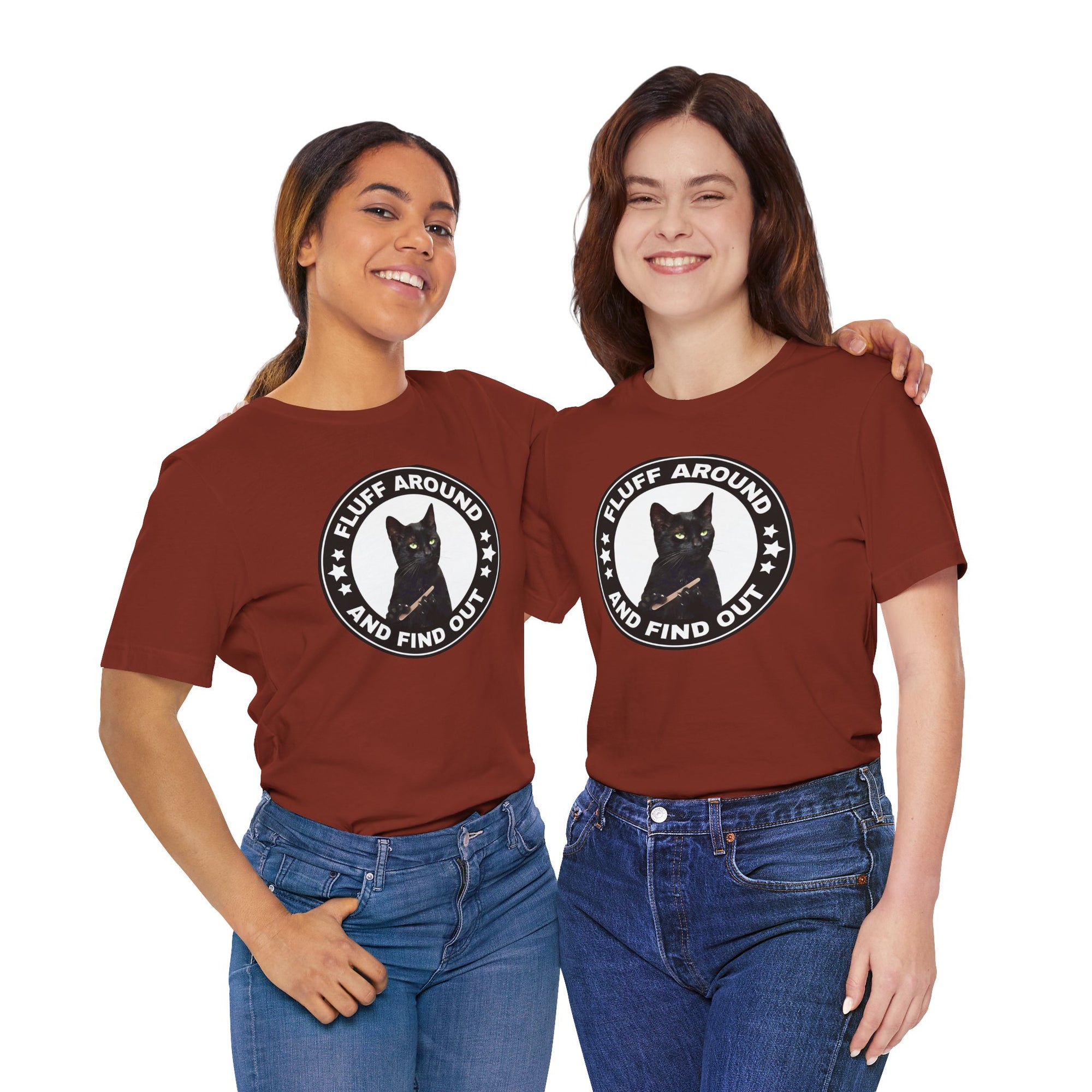 Two people wearing matching maroon t-shirt featuring a circular badge design with a black cat and the phrase “Fluff Around and Find Out.”