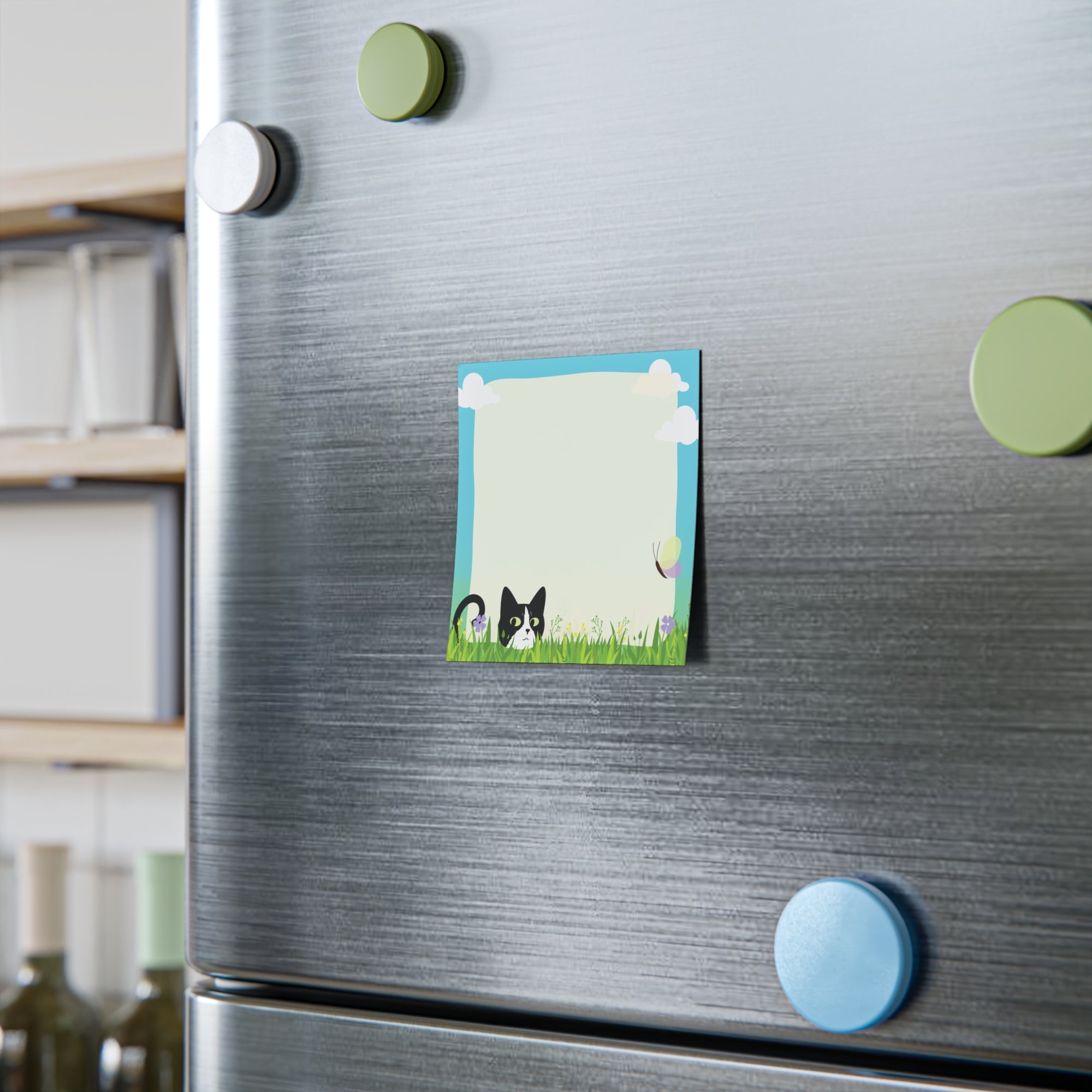 Stack of sticky notes with a black and white cat peeking from tall grass, flowers, clouds, and a light blank writing area in the center.

