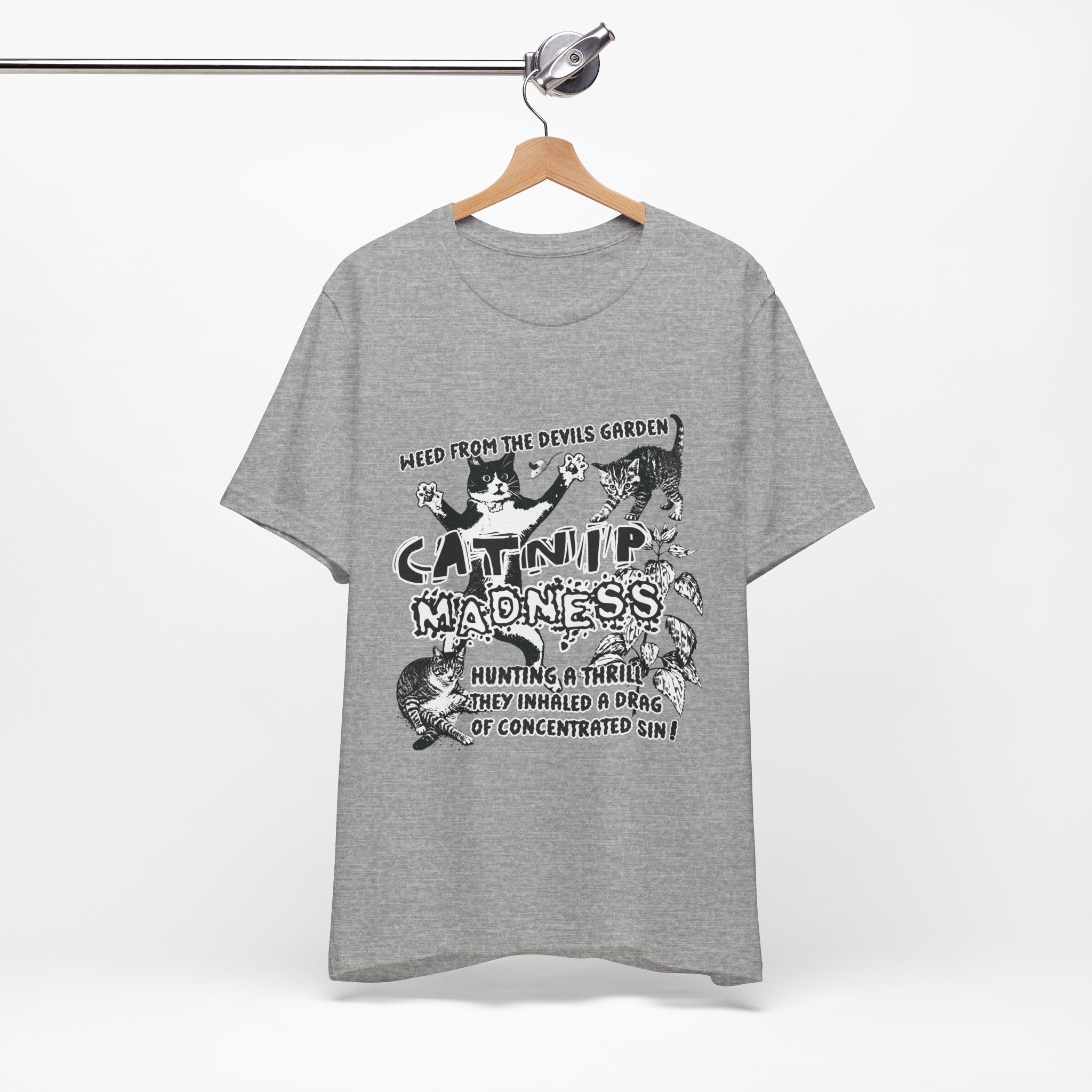 Gray t-shirt with graphic design and text on a hanger against a white background