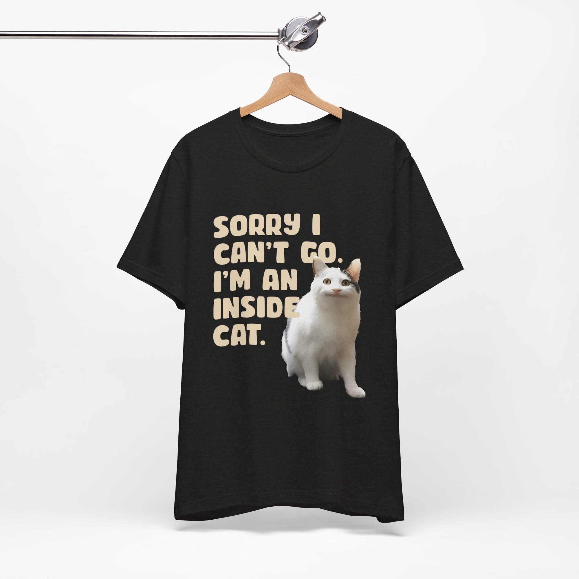 Black t-shirt with a cat graphic and text on a hanger against a white background
