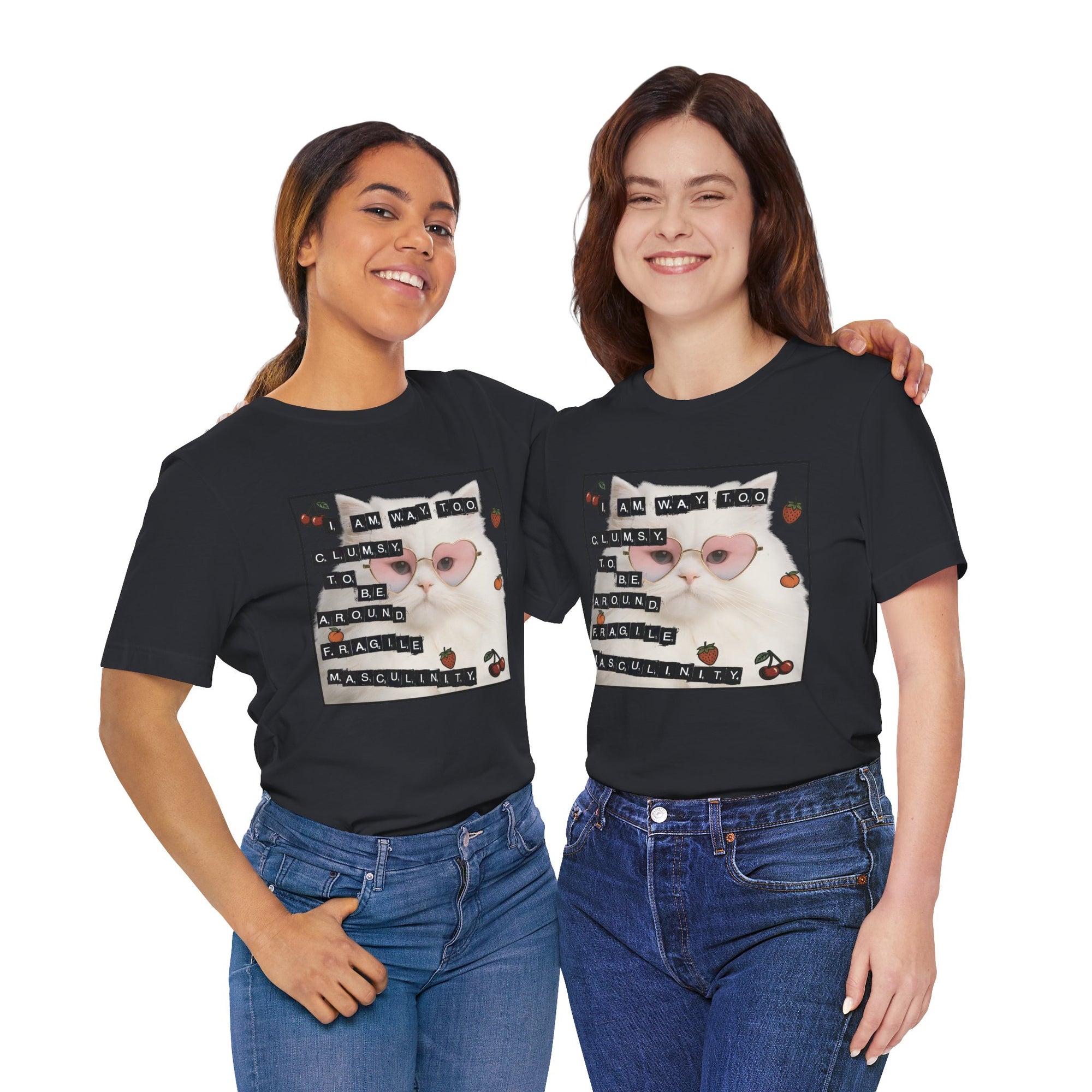 Two people wearing black t-shirt featuring a fluffy white cat in pink heart-shaped sunglasses with ransom-note style text that says “I am way too clumsy to be around fragile masculinity.”