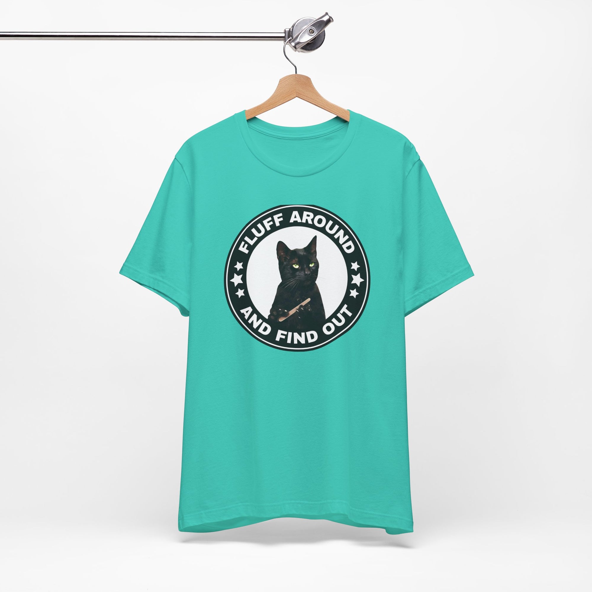 t-shirt featuring a circular badge design with a black cat and the phrase “Fluff Around and Find Out.”