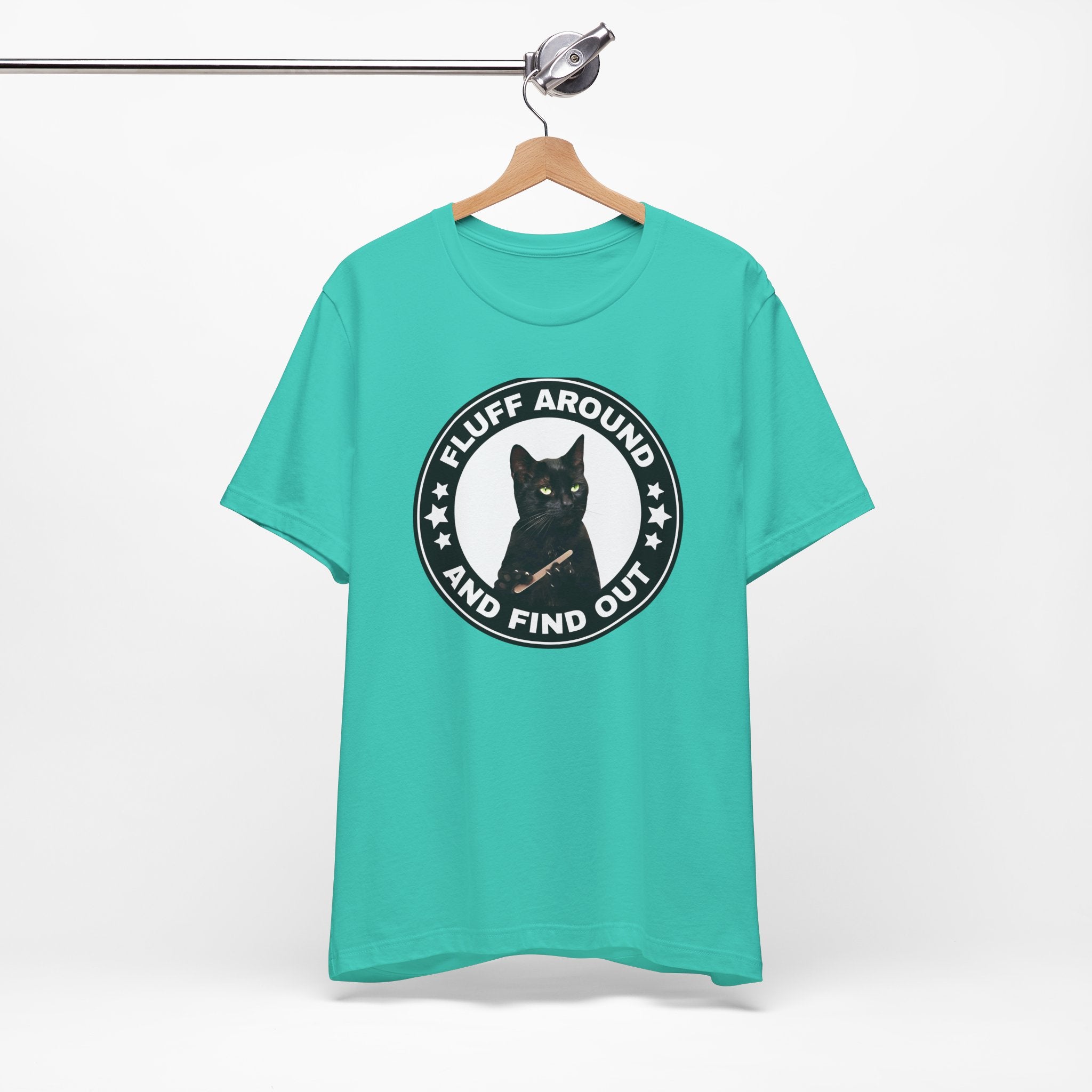 t-shirt featuring a circular badge design with a black cat and the phrase “Fluff Around and Find Out.”