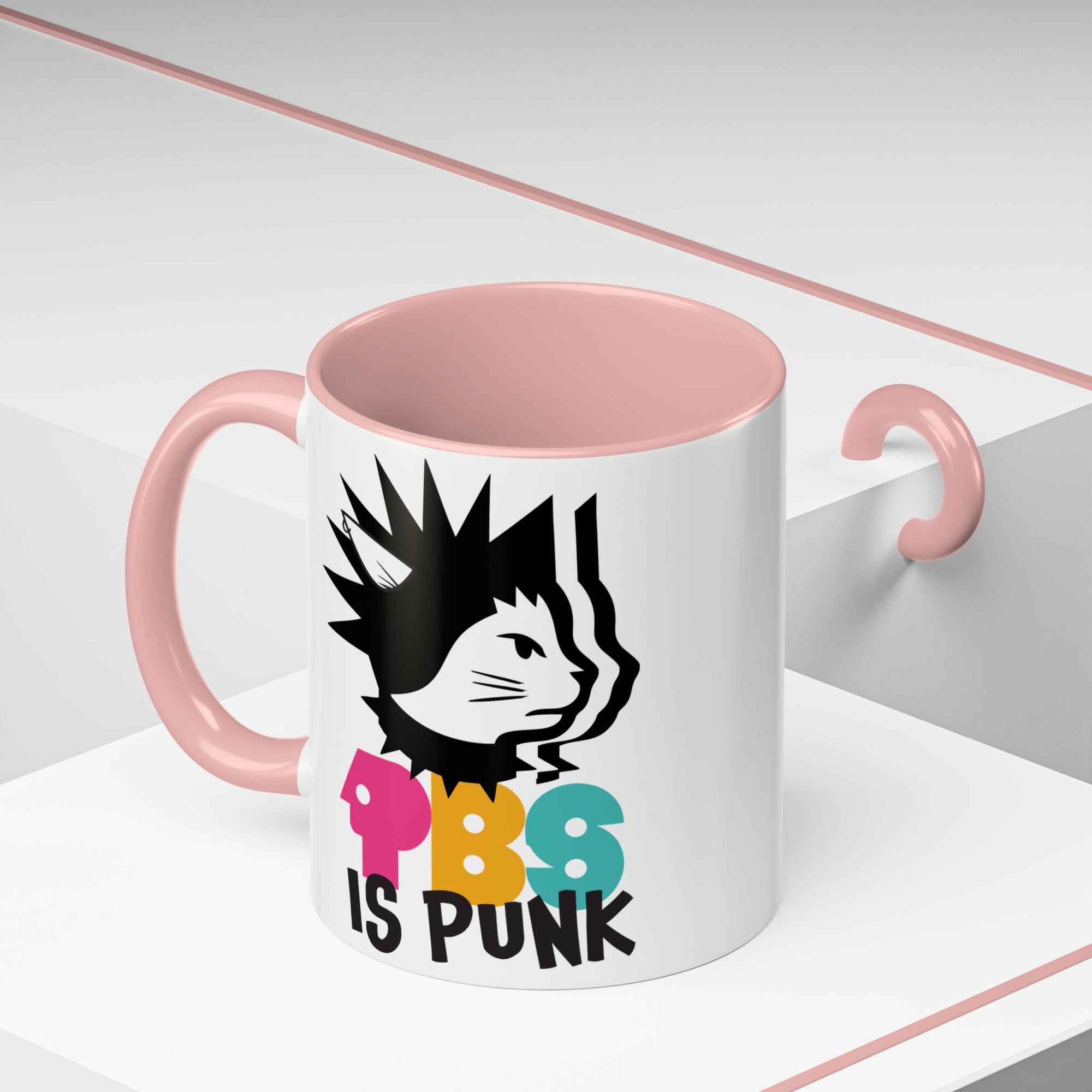Mug with pink interior and handle, featuring a black cat illustration and colorful text on a white background.