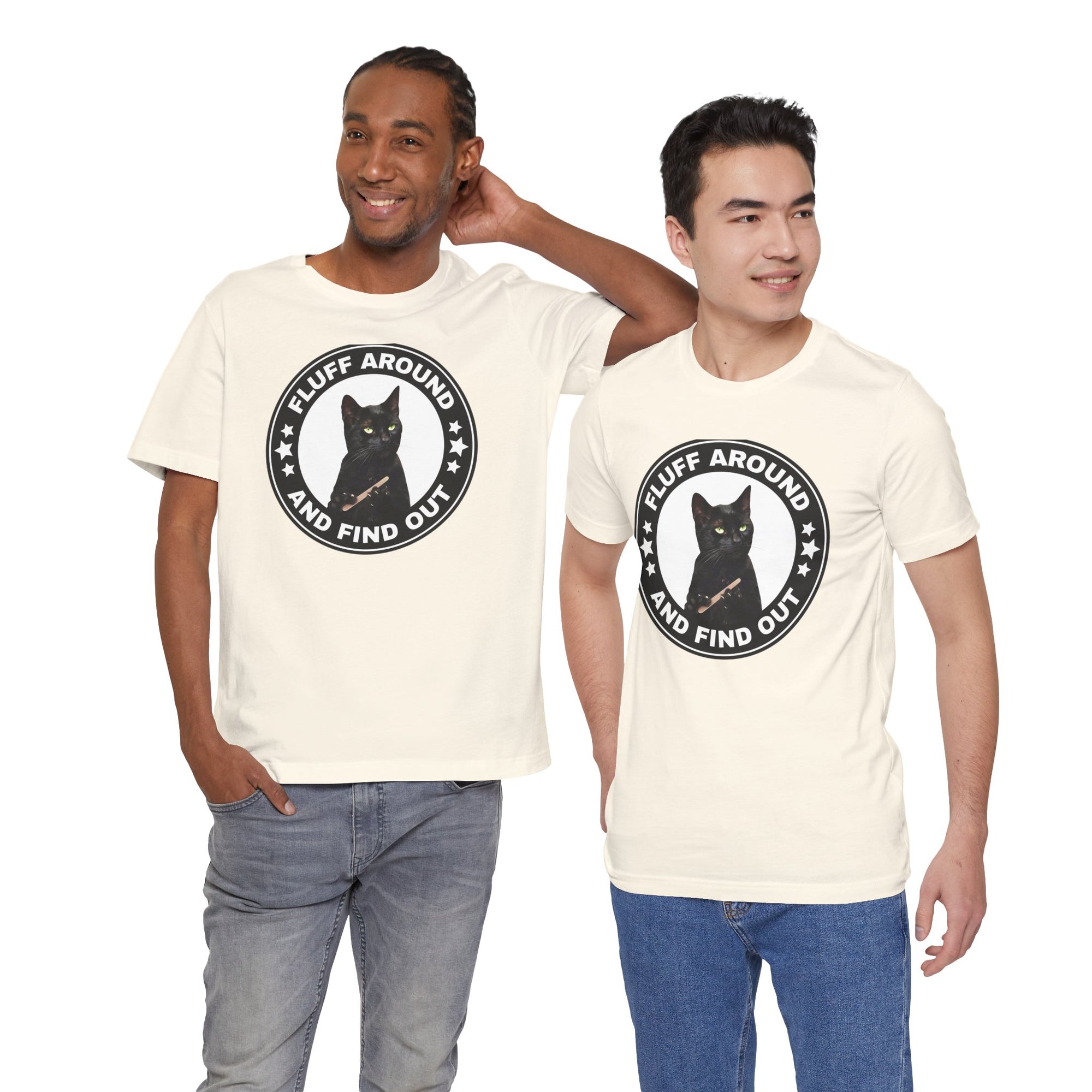 Two men wearing cream t-shirt featuring a circular badge design with a black cat and the phrase “Fluff Around and Find Out.”