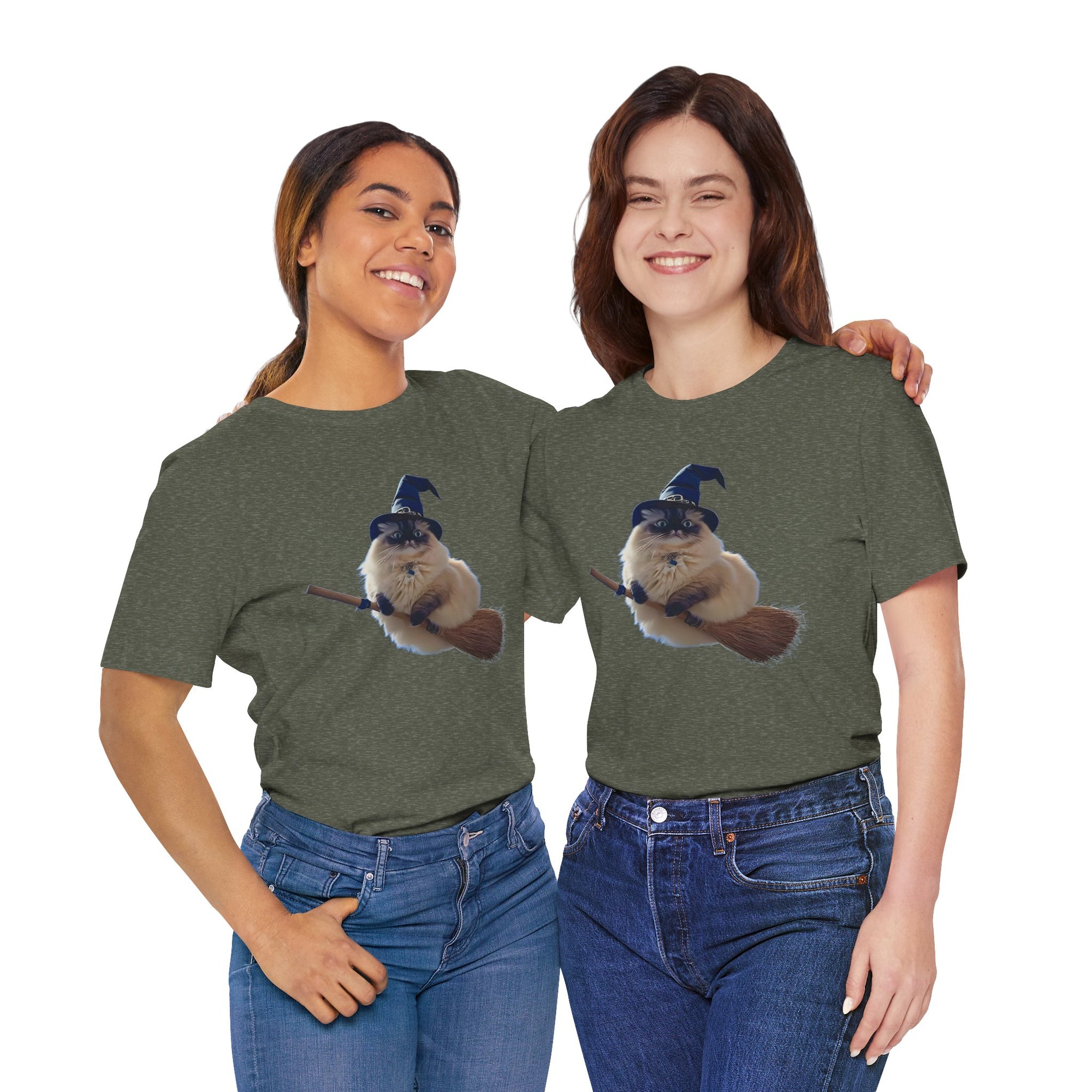 Two women wearing green t-shirts with a graphic of a cat wearing a witch hat and holding a broomstick.