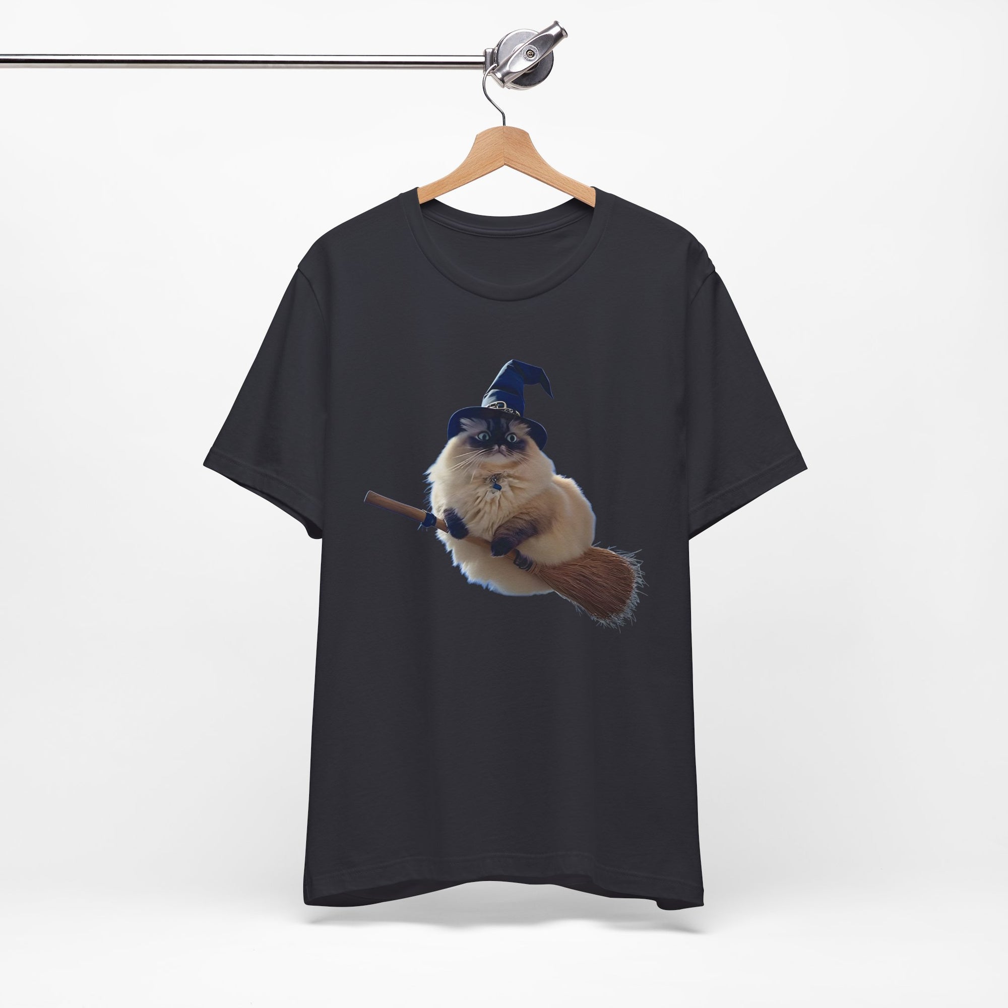 Black t-shirt with a graphic of a cat wearing a wizard hat and holding a broomstick, hanging on a wooden hanger against a white background.