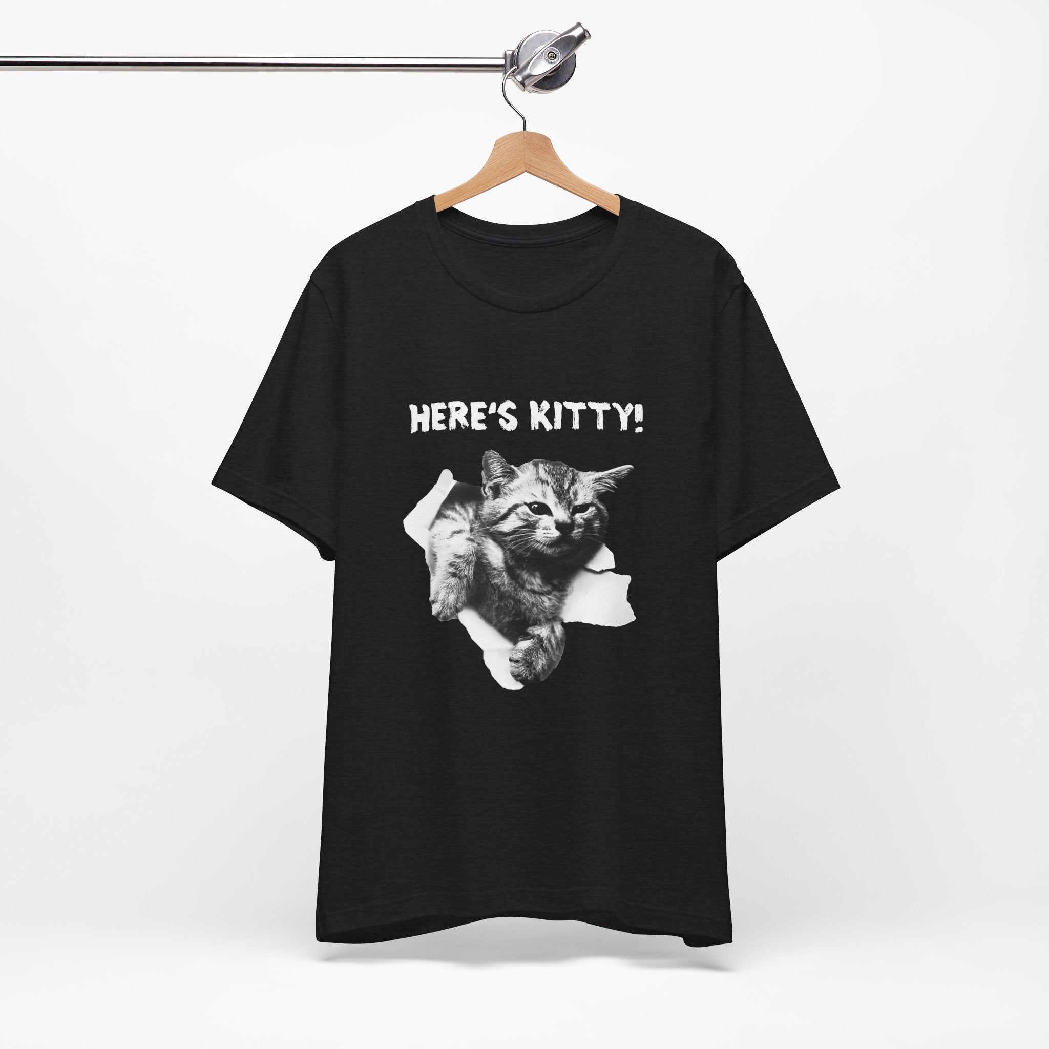Black t-shirt with a cat graphic and 'HERE'S KITTY!' text on a hanger against a white background