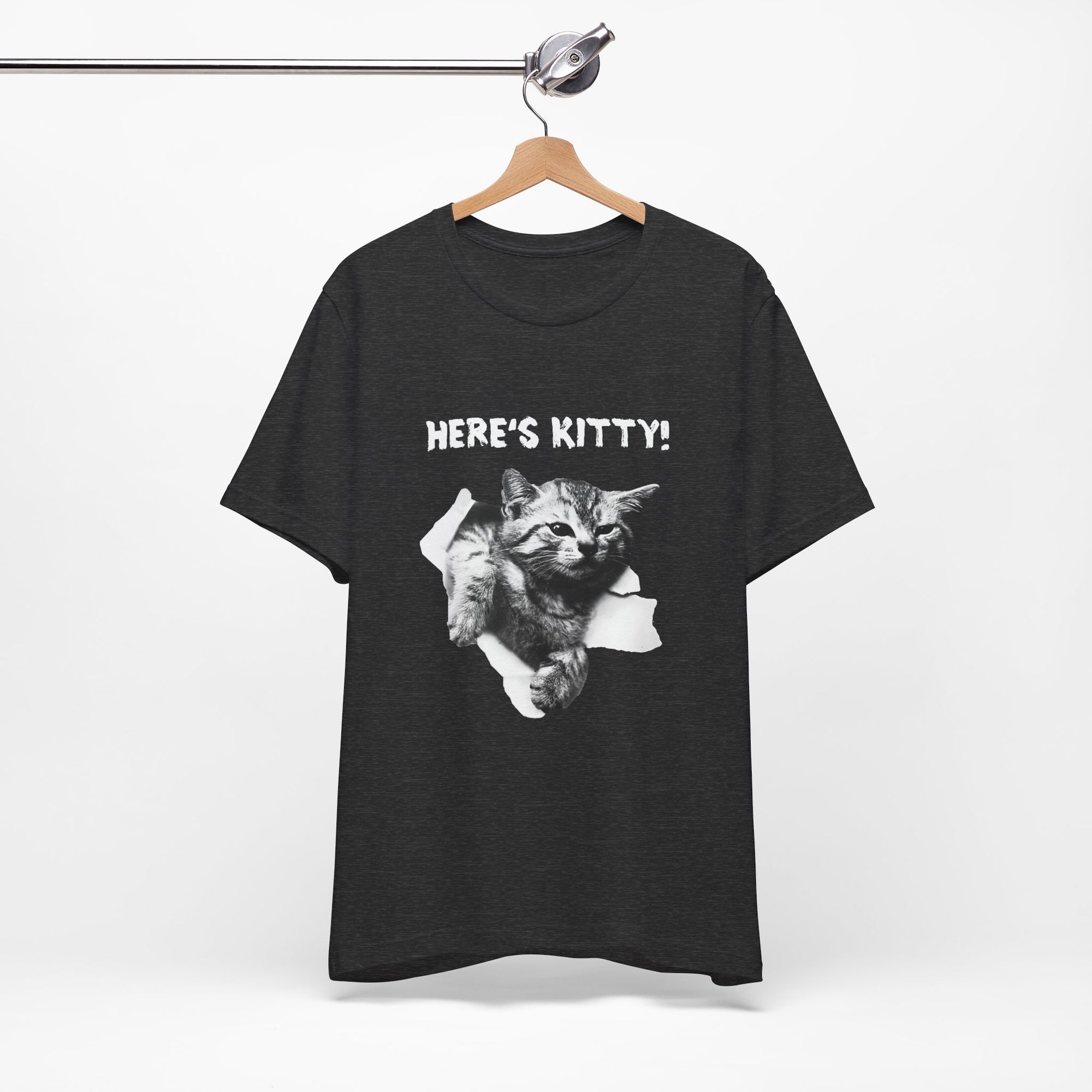 Black t-shirt with a graphic of a cat and 'HERE'S KITTY!' text on a hanger against a white background