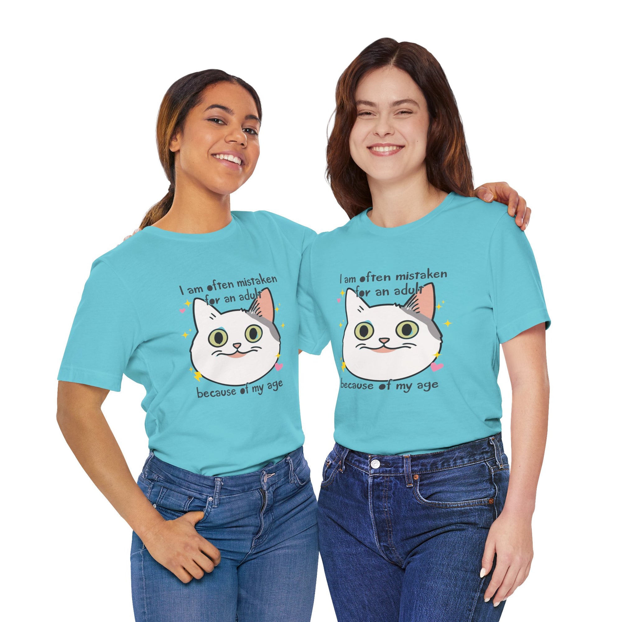 Two women wearing matching light blue t-shirts with a cat and text on a white background