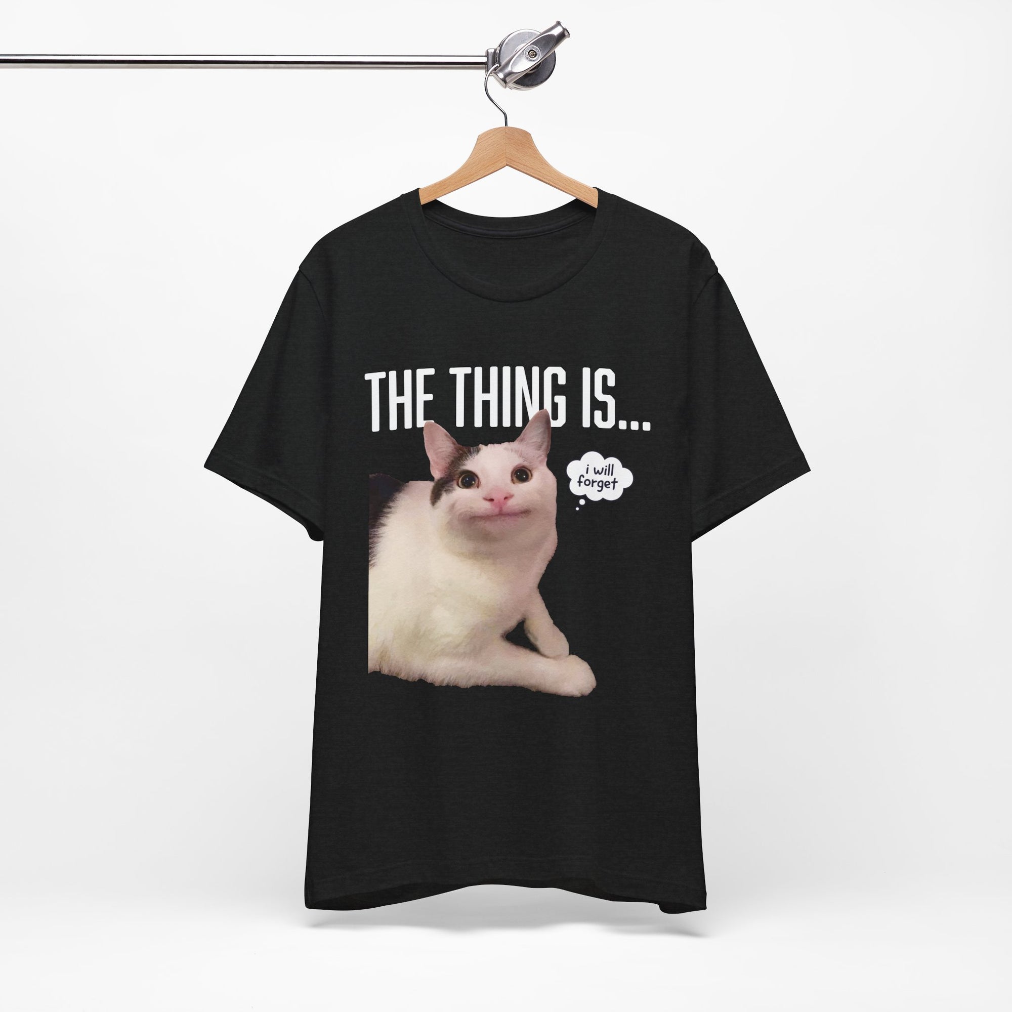 Black t-shirt with a cat graphic and text on a hanger against a white background