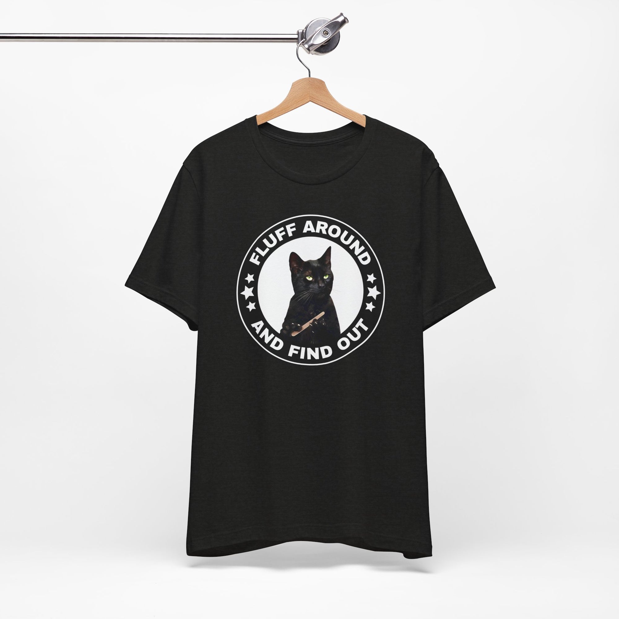 t-shirt featuring a circular badge design with a black cat and the phrase “Fluff Around and Find Out.”
