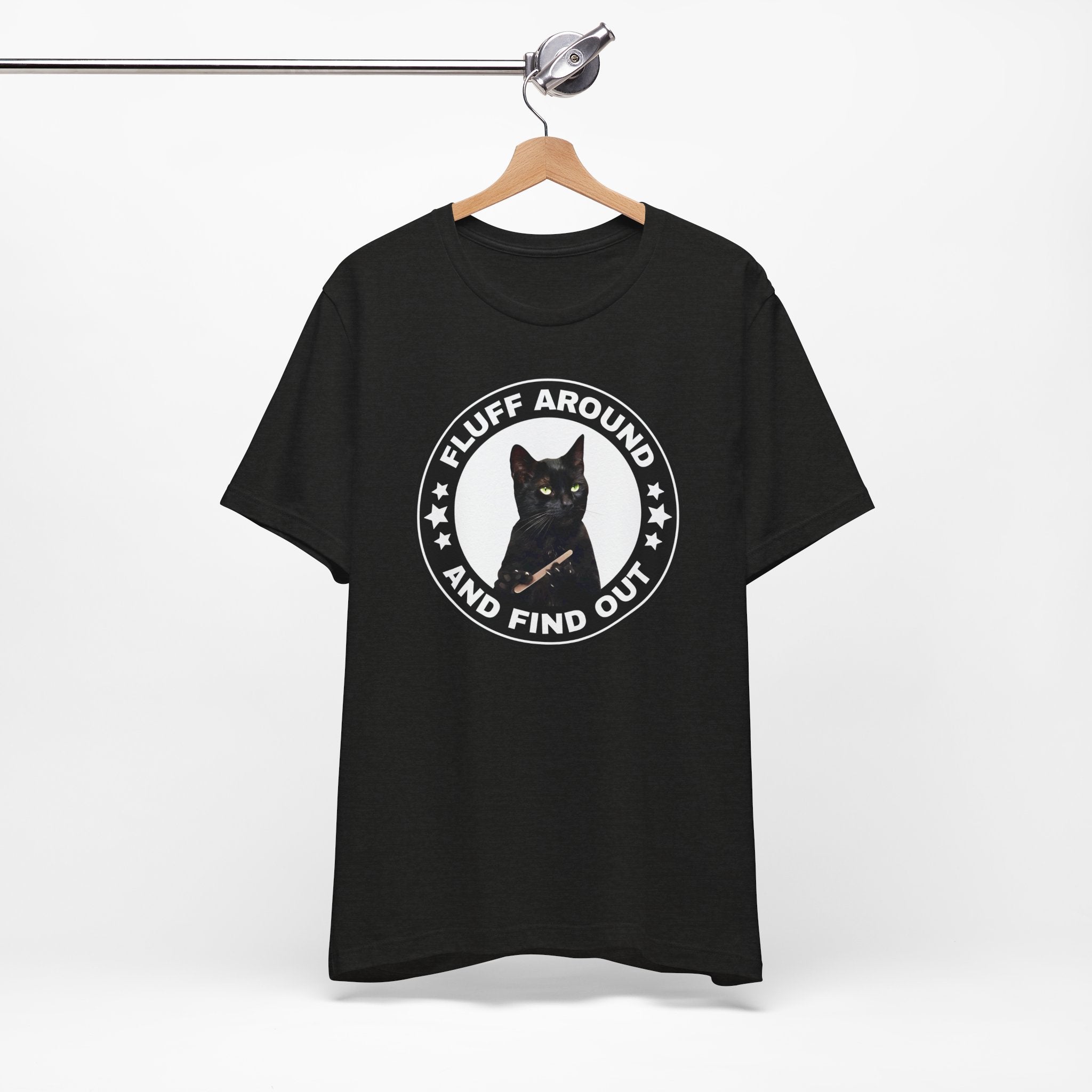 t-shirt featuring a circular badge design with a black cat and the phrase “Fluff Around and Find Out.”