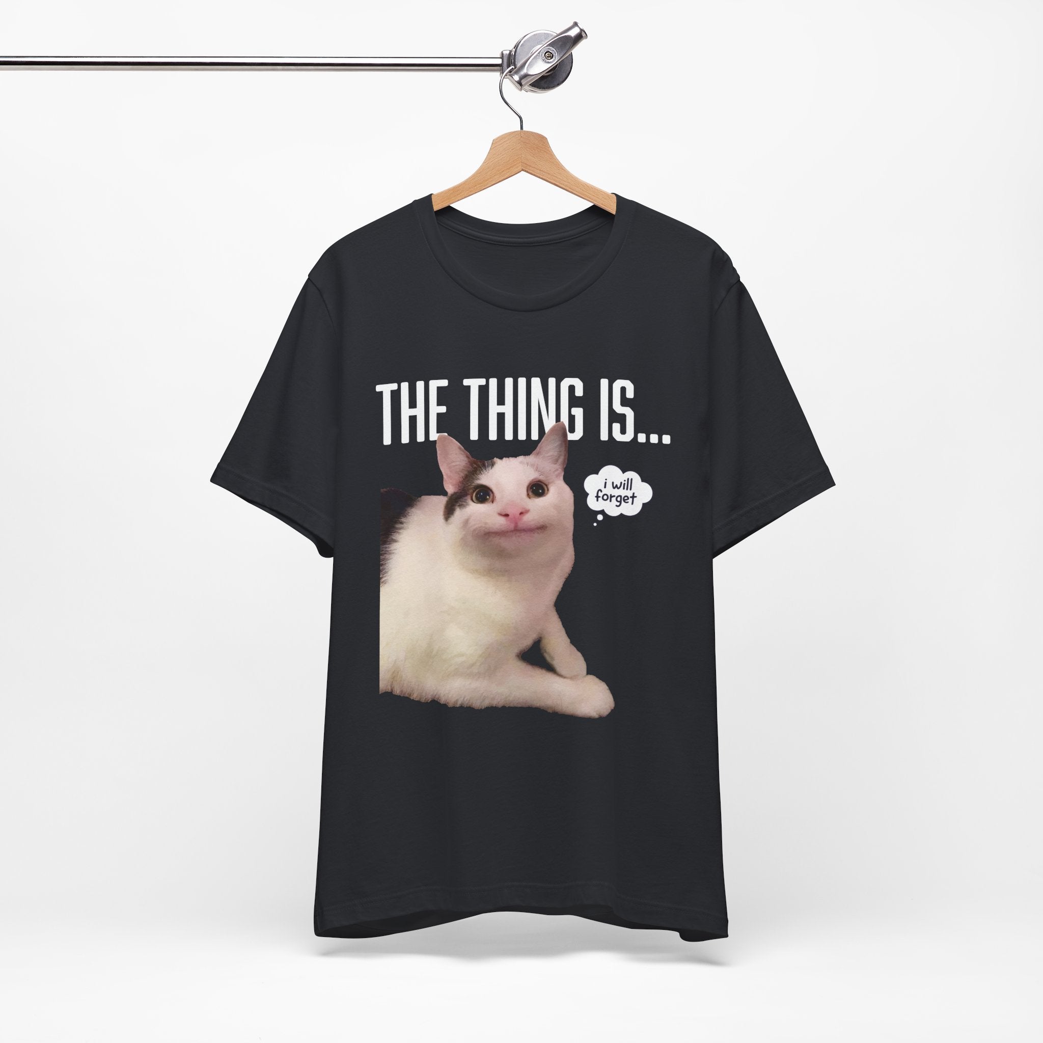 Black t-shirt with a cat graphic and text on a hanger against a white background