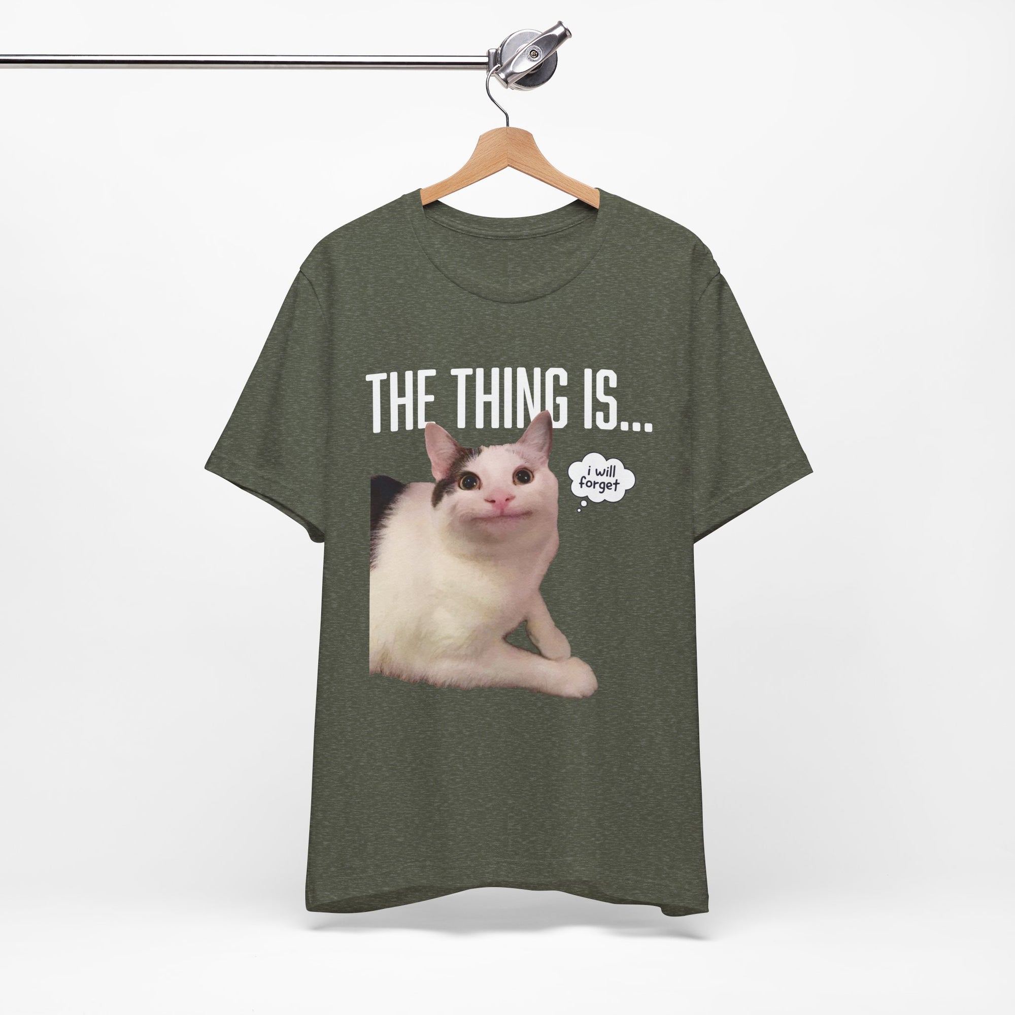 Green t-shirt with a cat graphic and text on a hanger against a white background