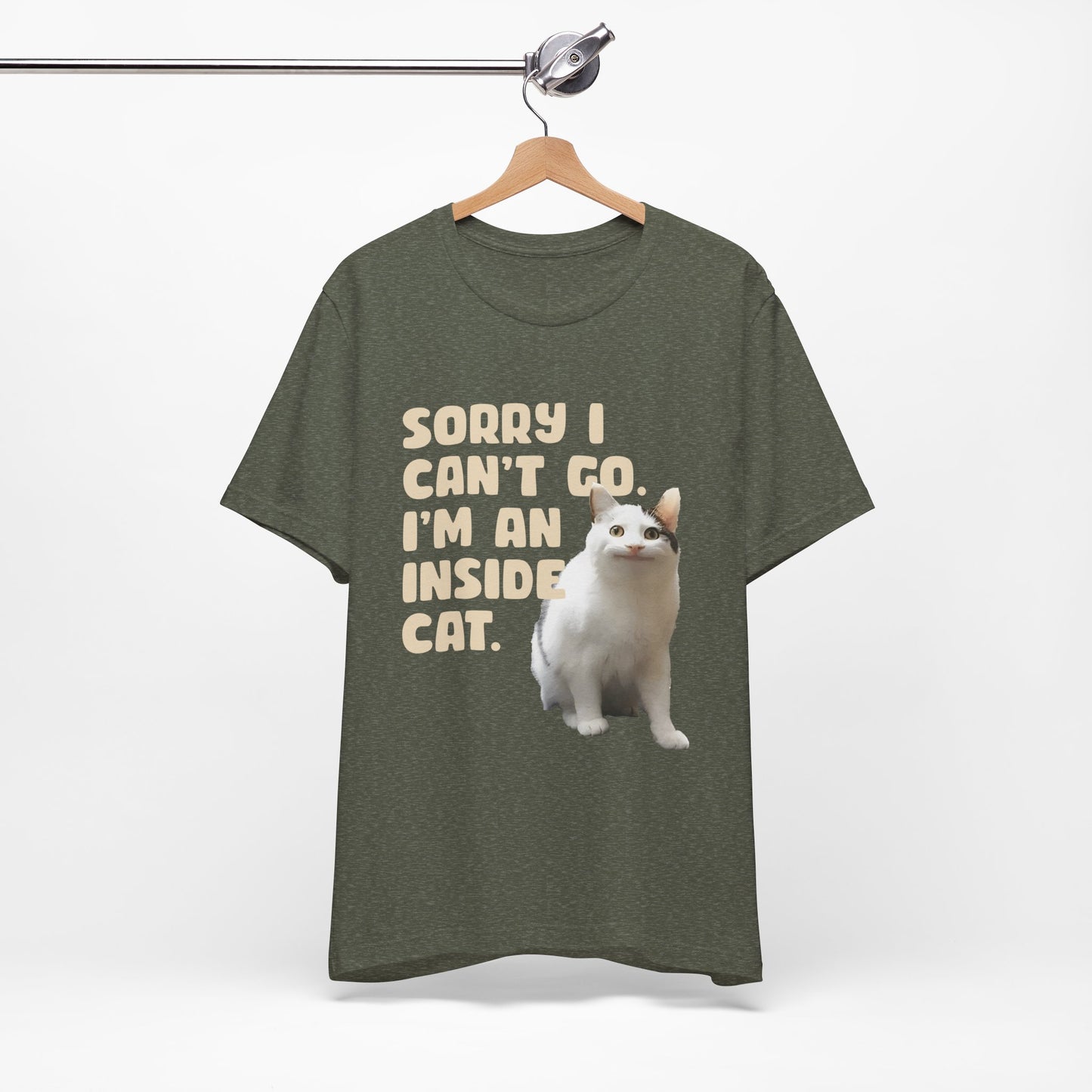 Brown t-shirt with a cat graphic and text on a hanger against a white background