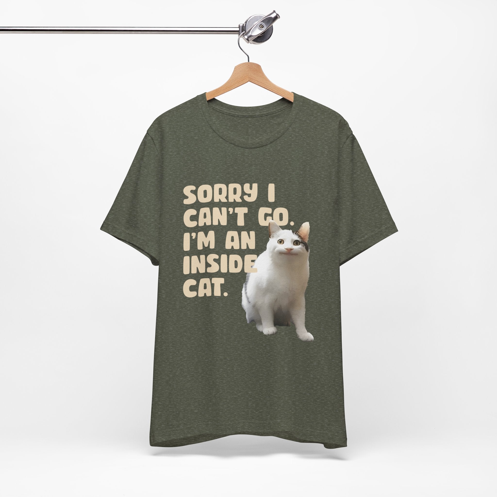 Brown t-shirt with a cat graphic and text on a hanger against a white background