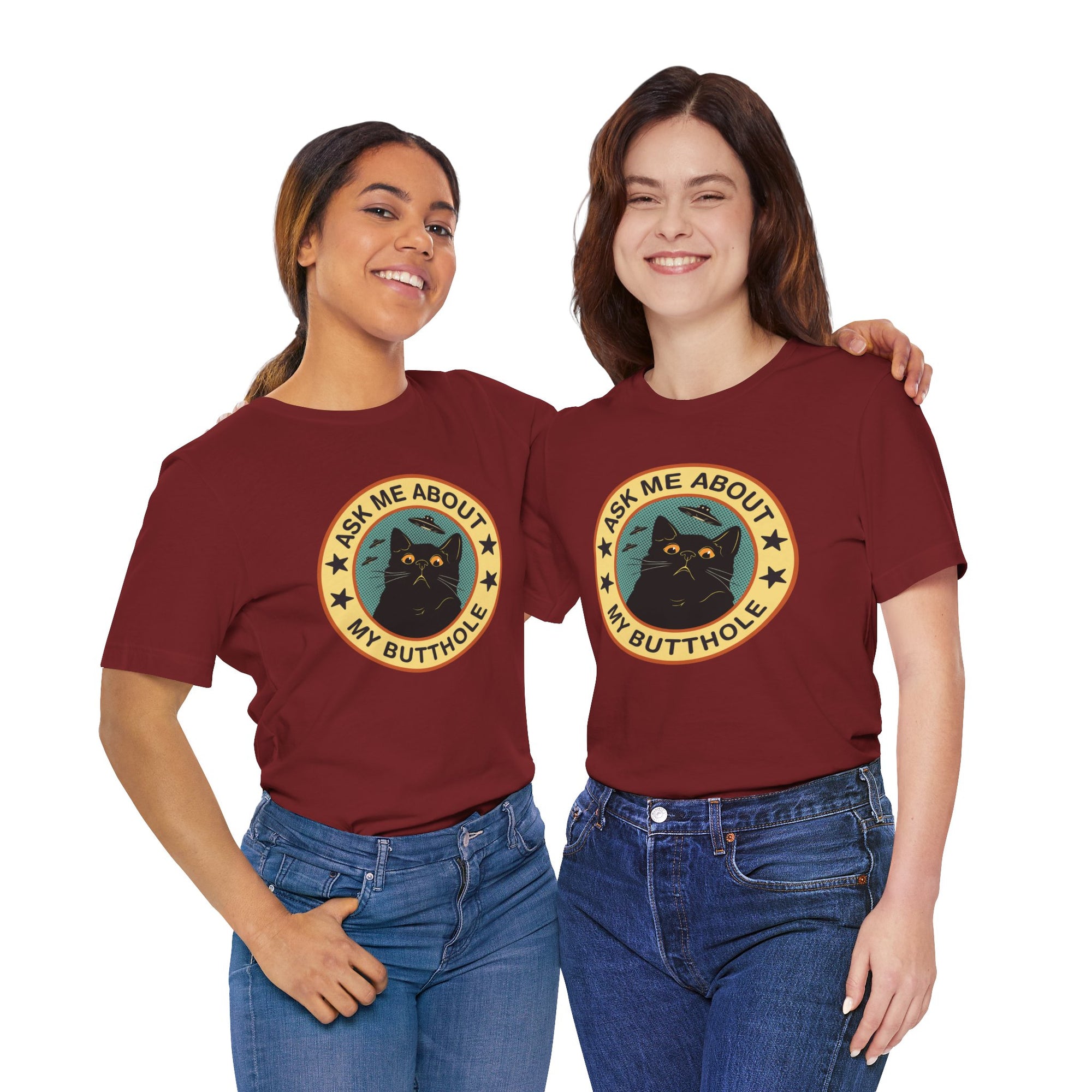 Two people wearing maroon t-shirts with a graphic of a cat and text on a white background