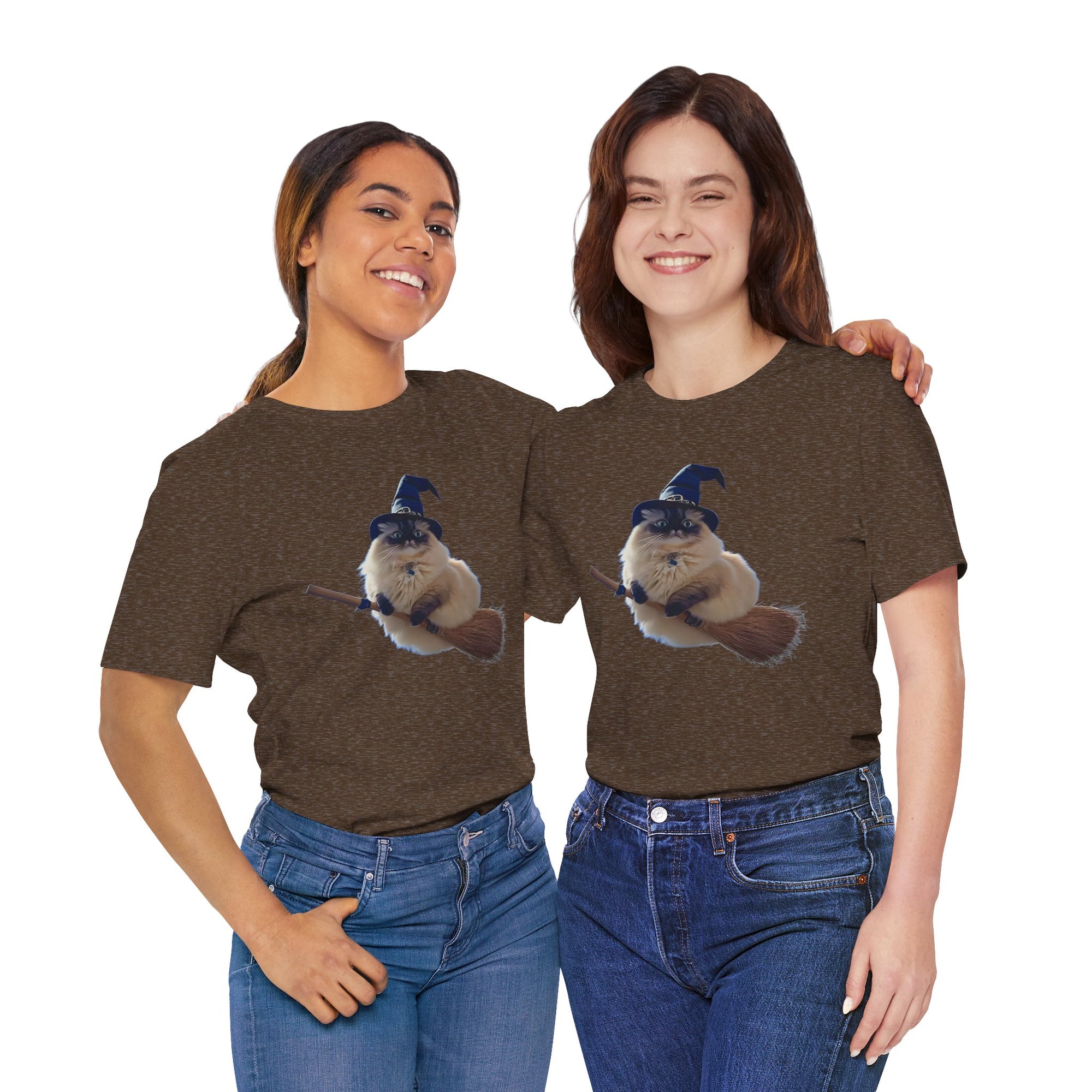 Two people wearing t-shirt featuring a fluffy cat wearing a witch hat and riding a broomstick.

