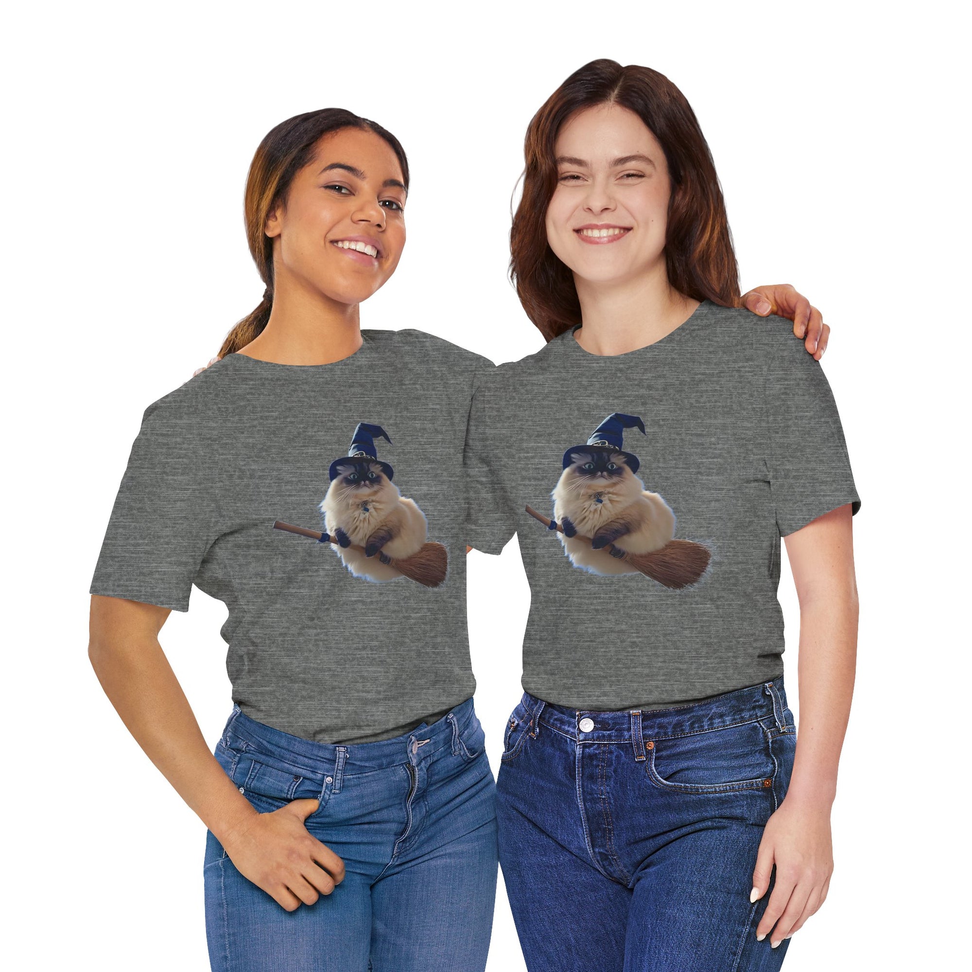 Two women wearing gray t-shirts with a fluffy cat wearing a blue witch hat and riding a broomstick.

