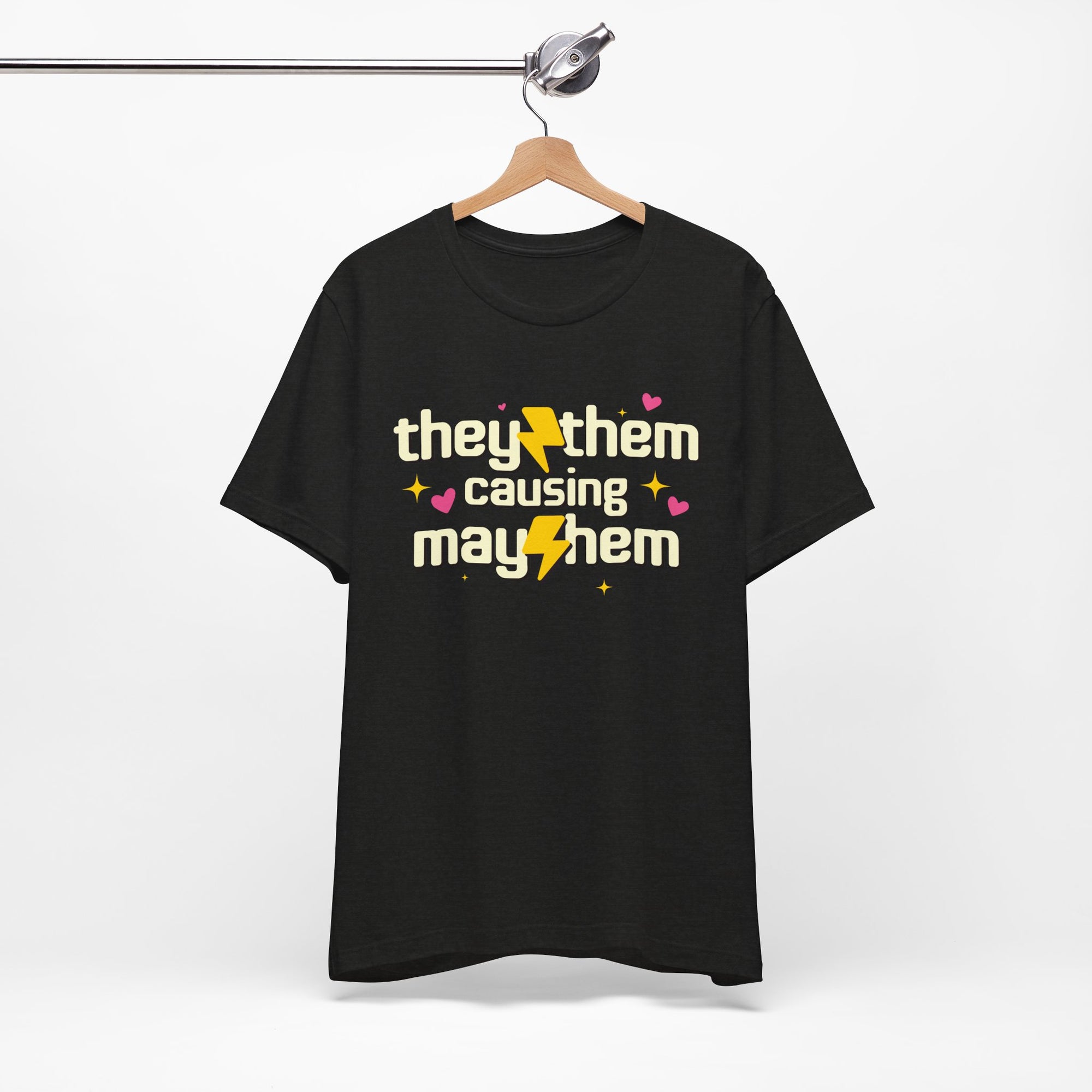 Black t-shirt with 'they them causing mayhem' text on a hanger against a white background