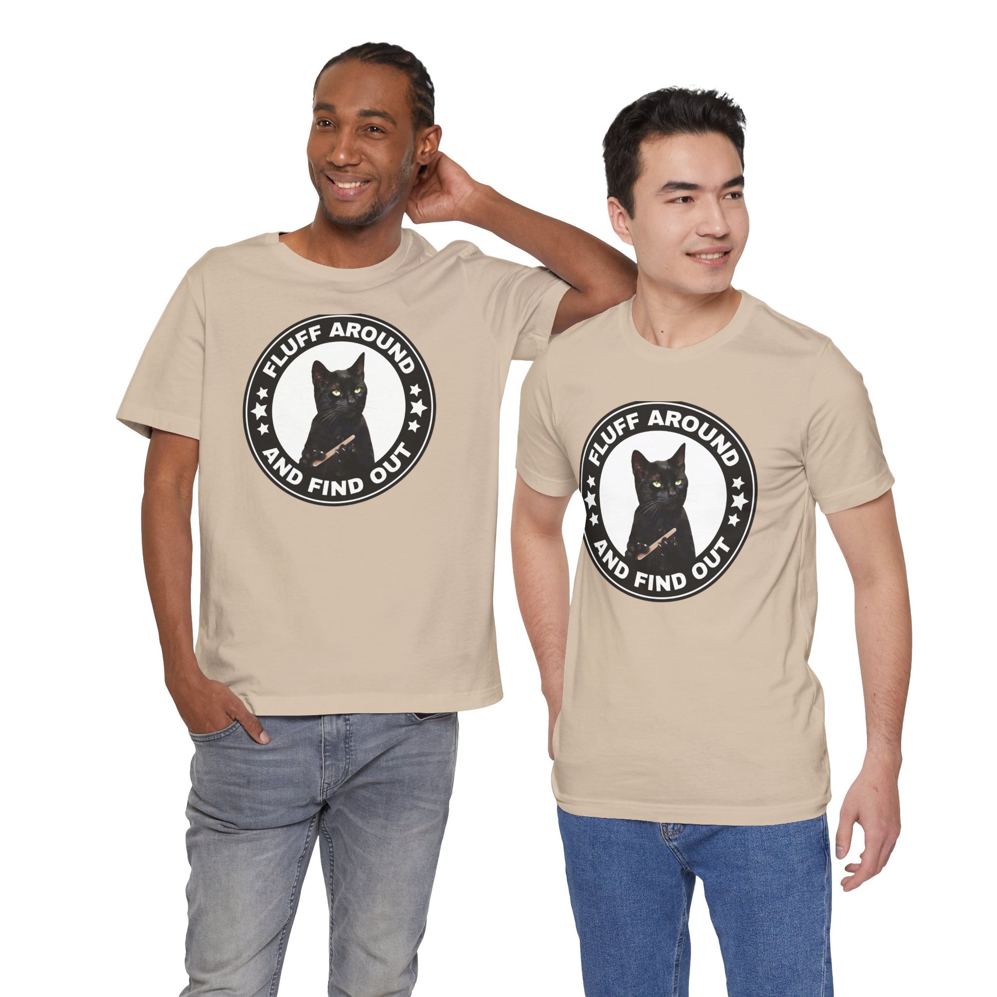 Two men wearing beige t-shirt featuring a circular badge design with a black cat and the phrase “Fluff Around and Find Out.”