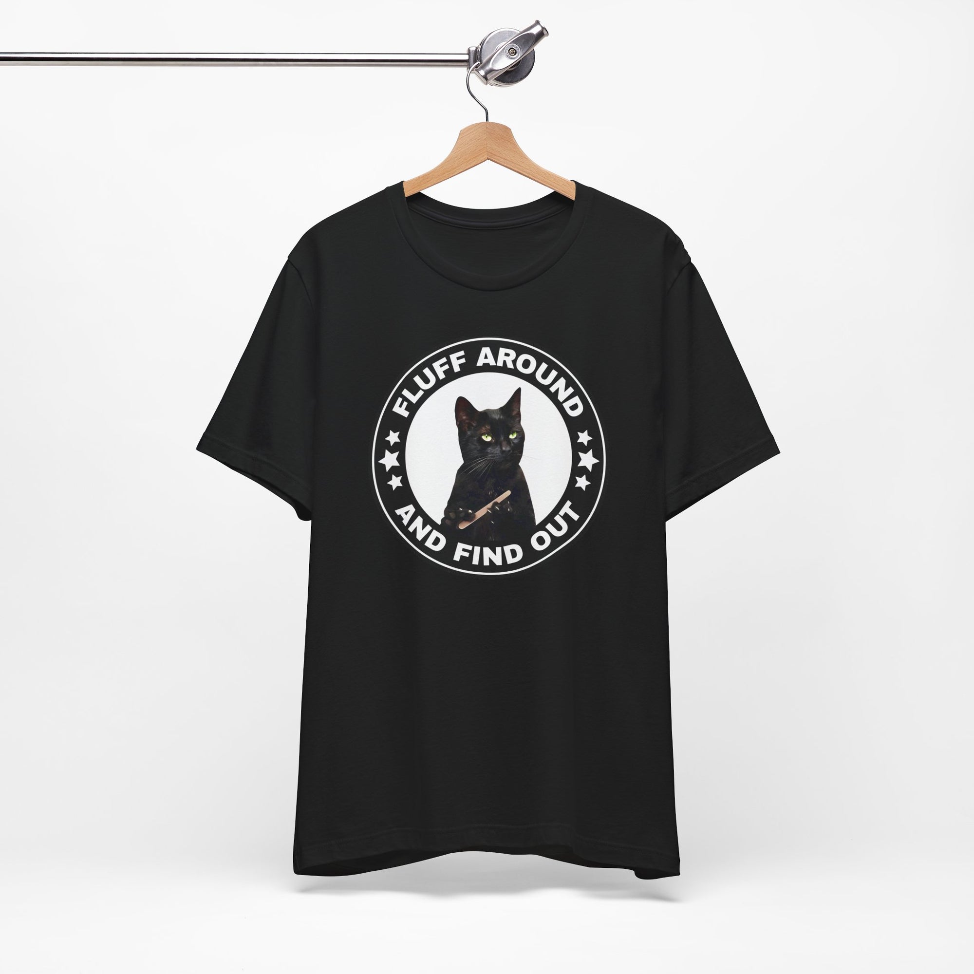 black t-shirt featuring a circular badge design with a black cat and the phrase “Fluff Around and Find Out.”

