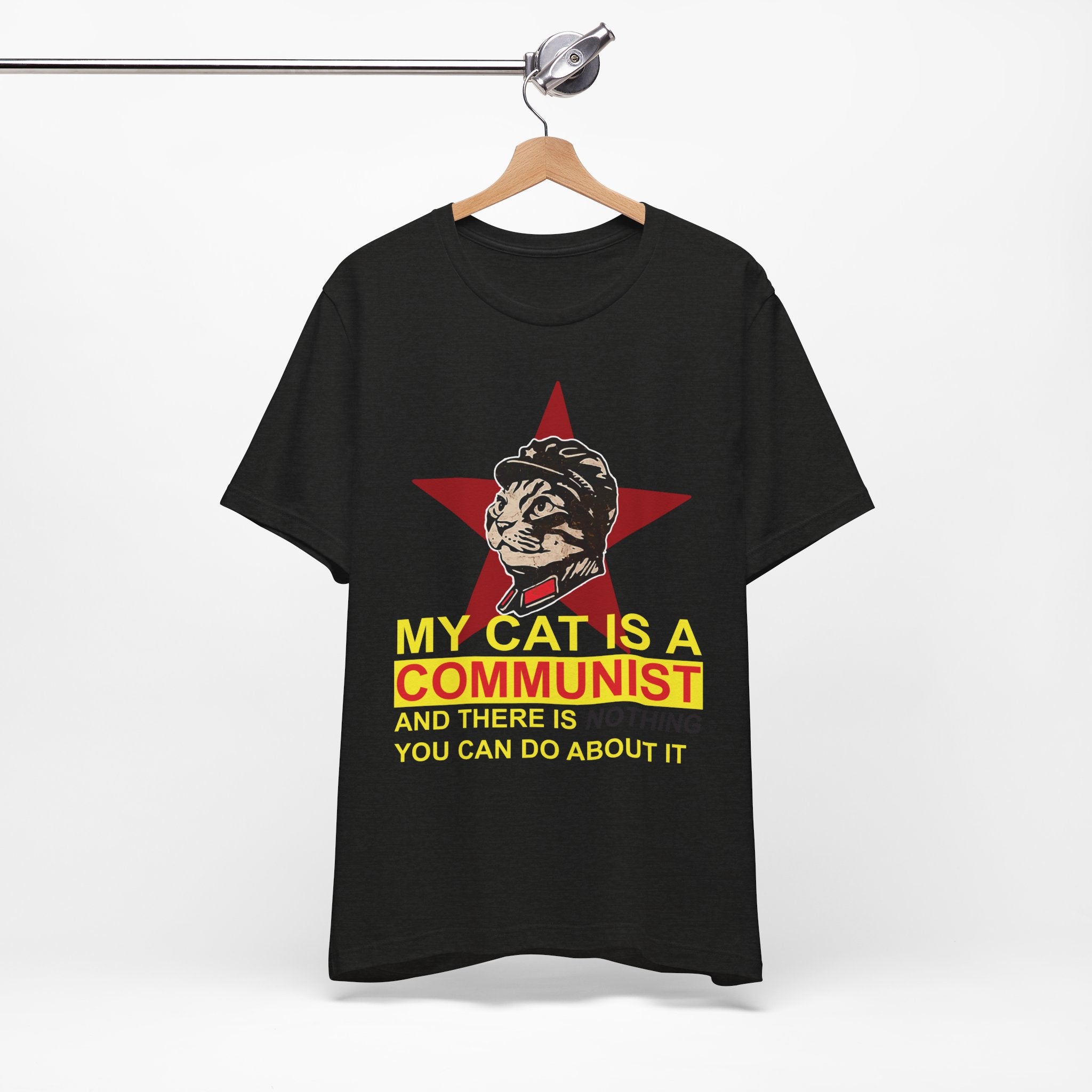 Black t-shirt with a graphic of a cat in a communist uniform and text on a hanger against a white background