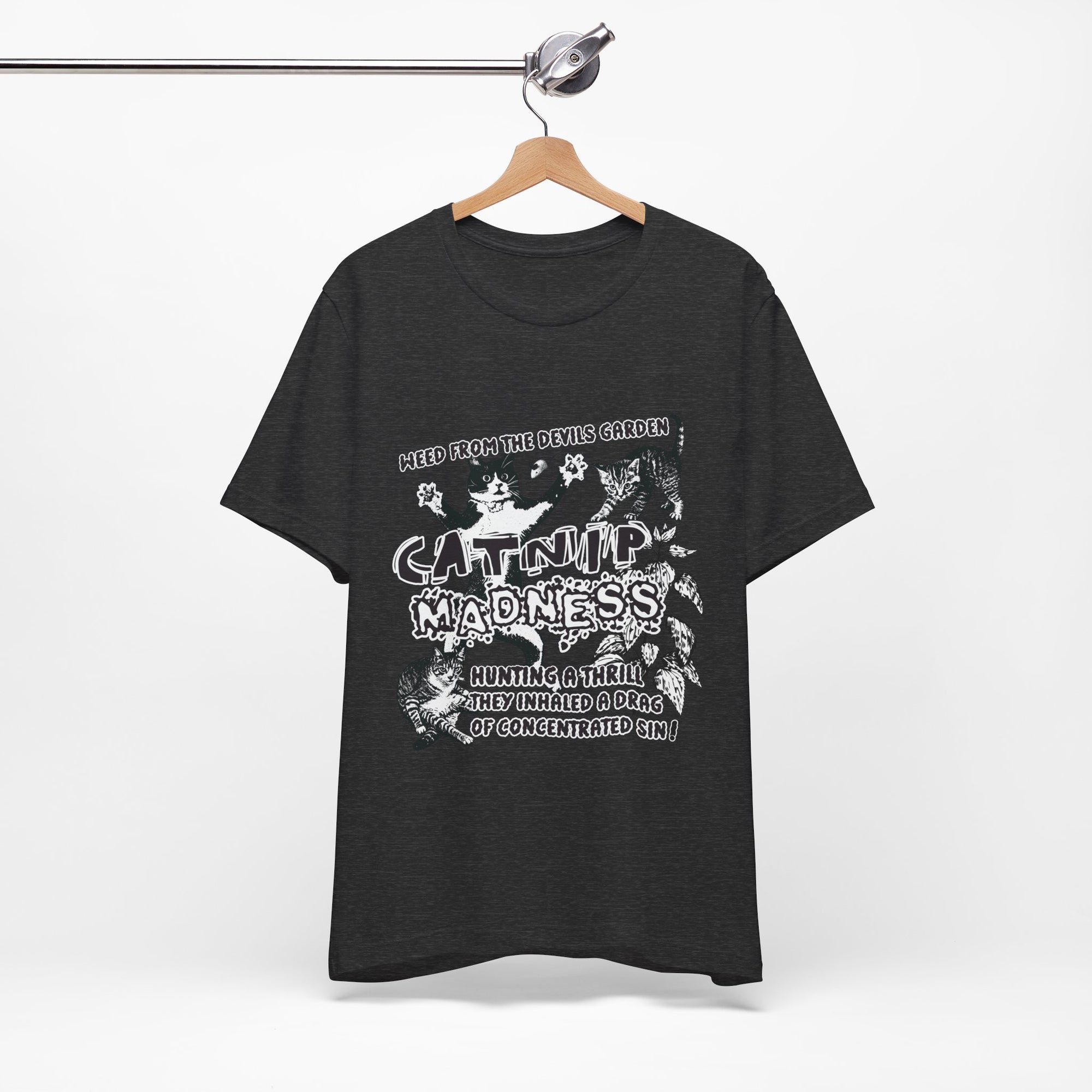 Black t-shirt with white graphic design on a hanger against a white background