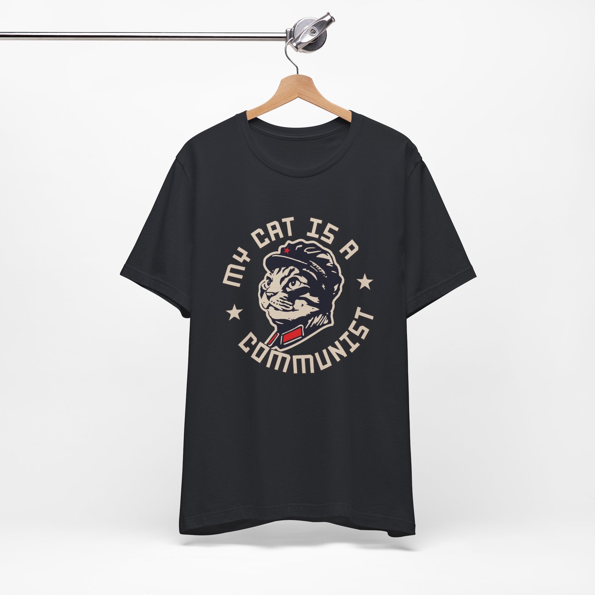 Black t-shirt with a graphic design of a cat and text on a hanger against a white background